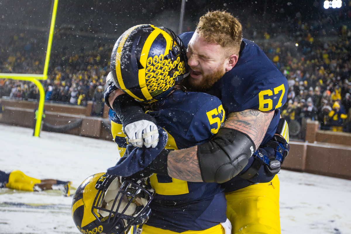  Michigan's offensive lineman Mason Cole (52), left and Michigan's offensive lineman Kyle Kalis (67) celebrate after the completion of the game between the Michigan Wolverines and the Indiana Hoosiers at Michigan Stadium on Saturday, November 19, 201