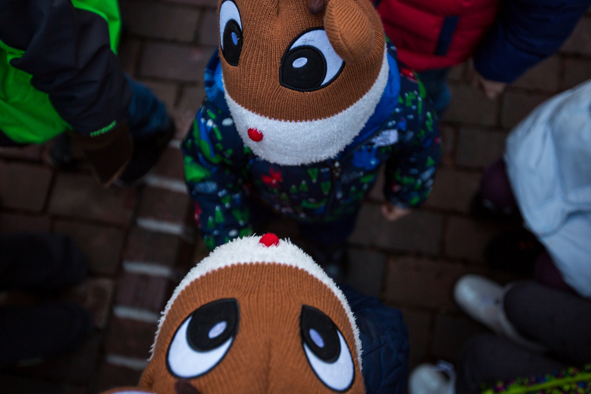  Lucas Ailuni, bottom, 2 and older brother Elias, 4, talk with each other while wearing Rudolph hats at the Kerrytown Christmas tree lighting on Sunday, November 27, 2016. The lighting, which took place at the Kerrytown Market and Shops, featured sin