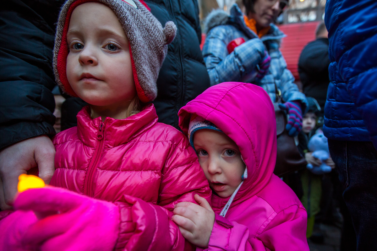  Corinne Marks, 6, left and her younger sister Truett, 4, eagerly wait the arrival of Santa at the Kerrytown Christmas tree lighting on Sunday, November 27, 2016. The lighting, which took place at the Kerrytown Market and Shops, featured singing from
