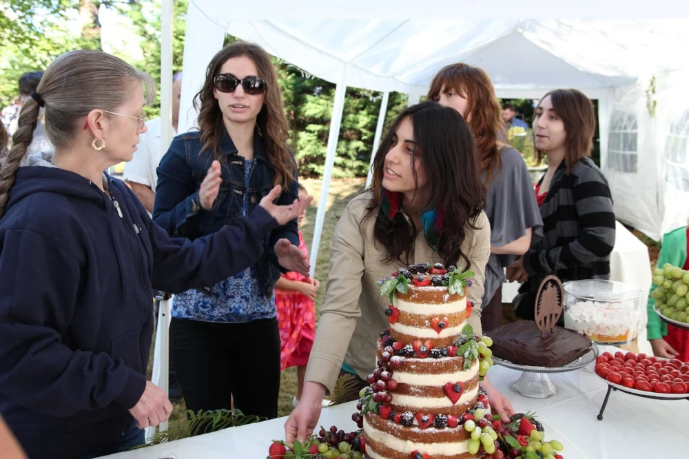 My sister and nieces bringing in the beautiful cake they made. 