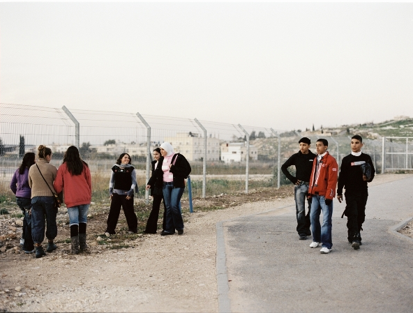 The young journalists from Israel welcome the young journalists from the West Bank as they cross the checkpoint (2007). Dealing with reality is part of their routine, so is asking many questions about this reality.