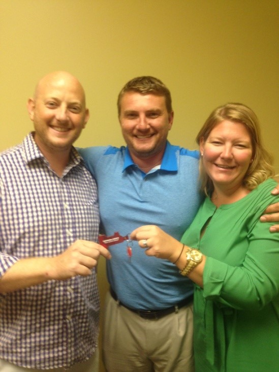 Melissa and her husband (the happy homeowners!) with their agent