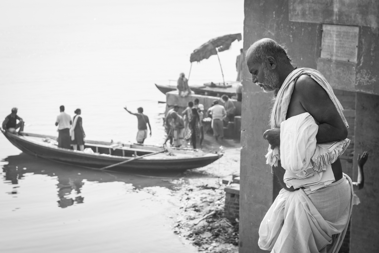 A man gets ready for his bath in the river Ganges.