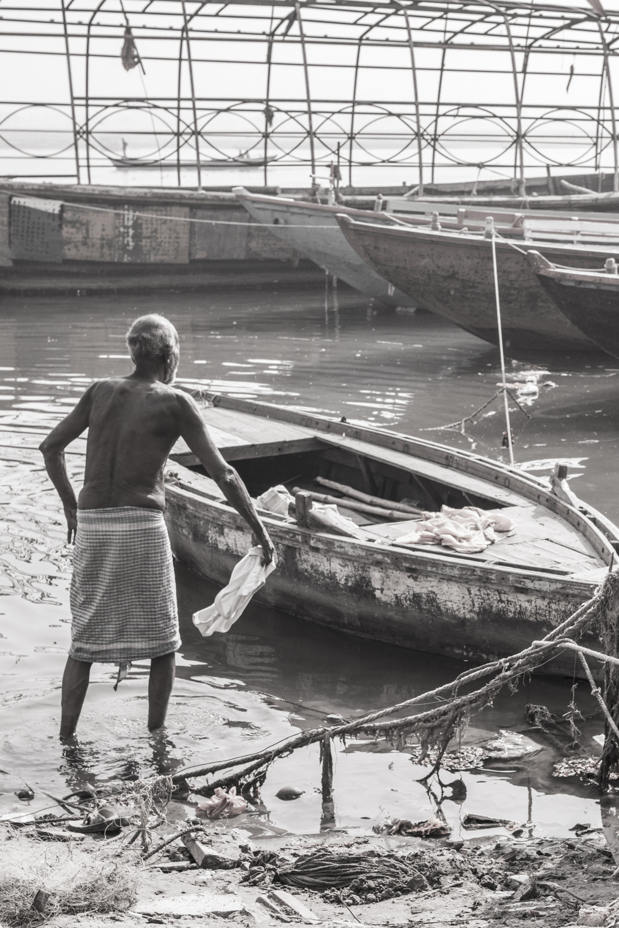 The holy river of Ganges is used for pretty much everything. This man is cleaning his clothes after a bath.