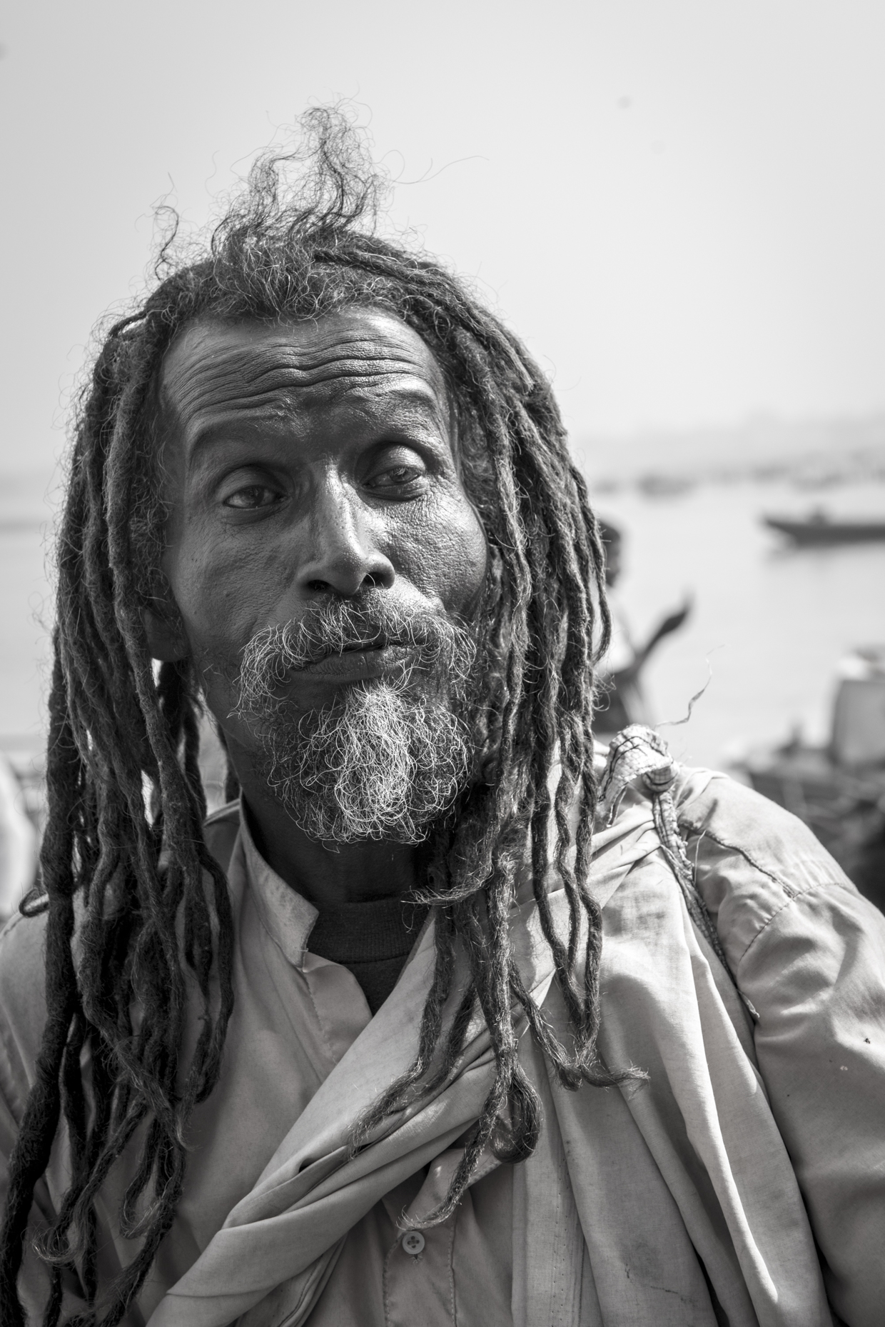 A homeless man walking around the river Ganges in Varanasi.