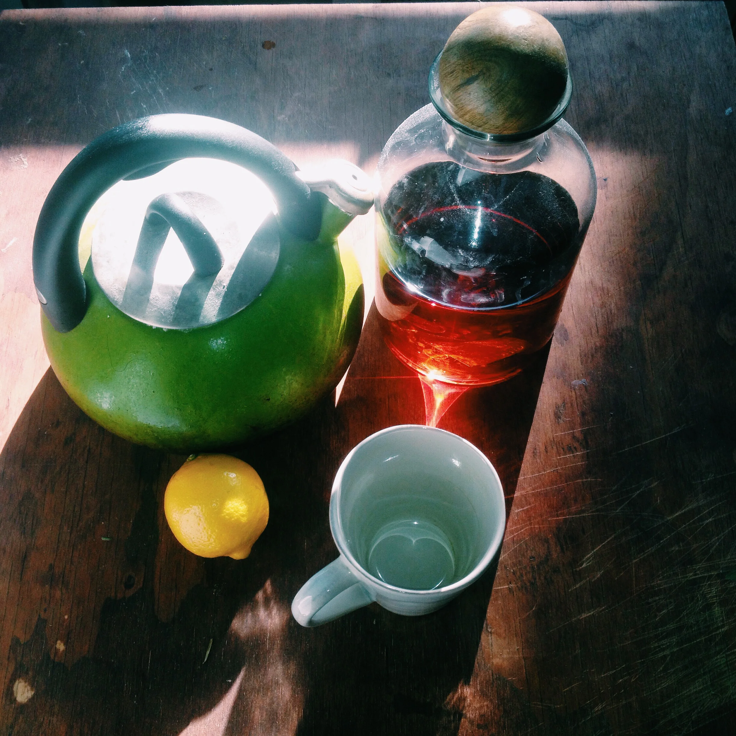Assemble your ingredients. You'll need some spicy rum, a lemon, a cup of boiling water and some honey, which I actually forgot to include in this photo because I'm new at this, ok.