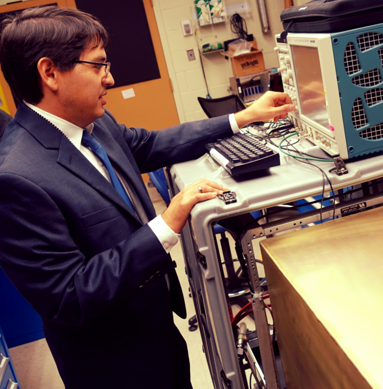 Dr. Nishimura examining picosecond laser pulse readouts at the NIST mini-timecube (MTC) test site in Gaithersburg, Maryland, 2015.