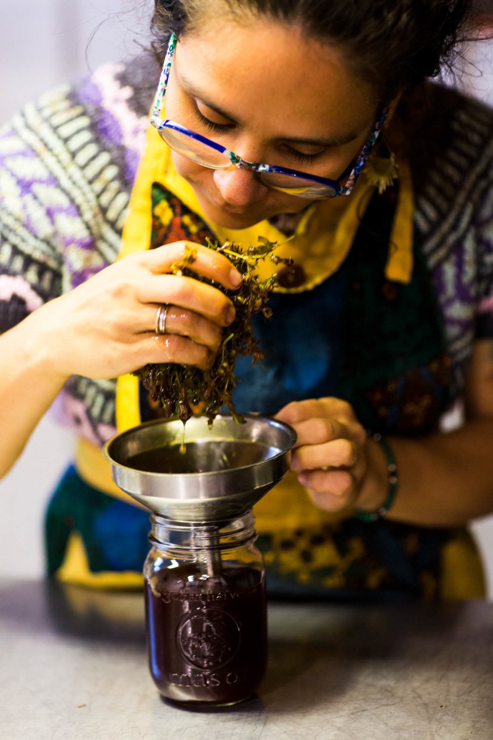  Artisan Celia Jimenez from Cucamanga checks an infusion of St John's Wort at her home studio in the Laurentians. 