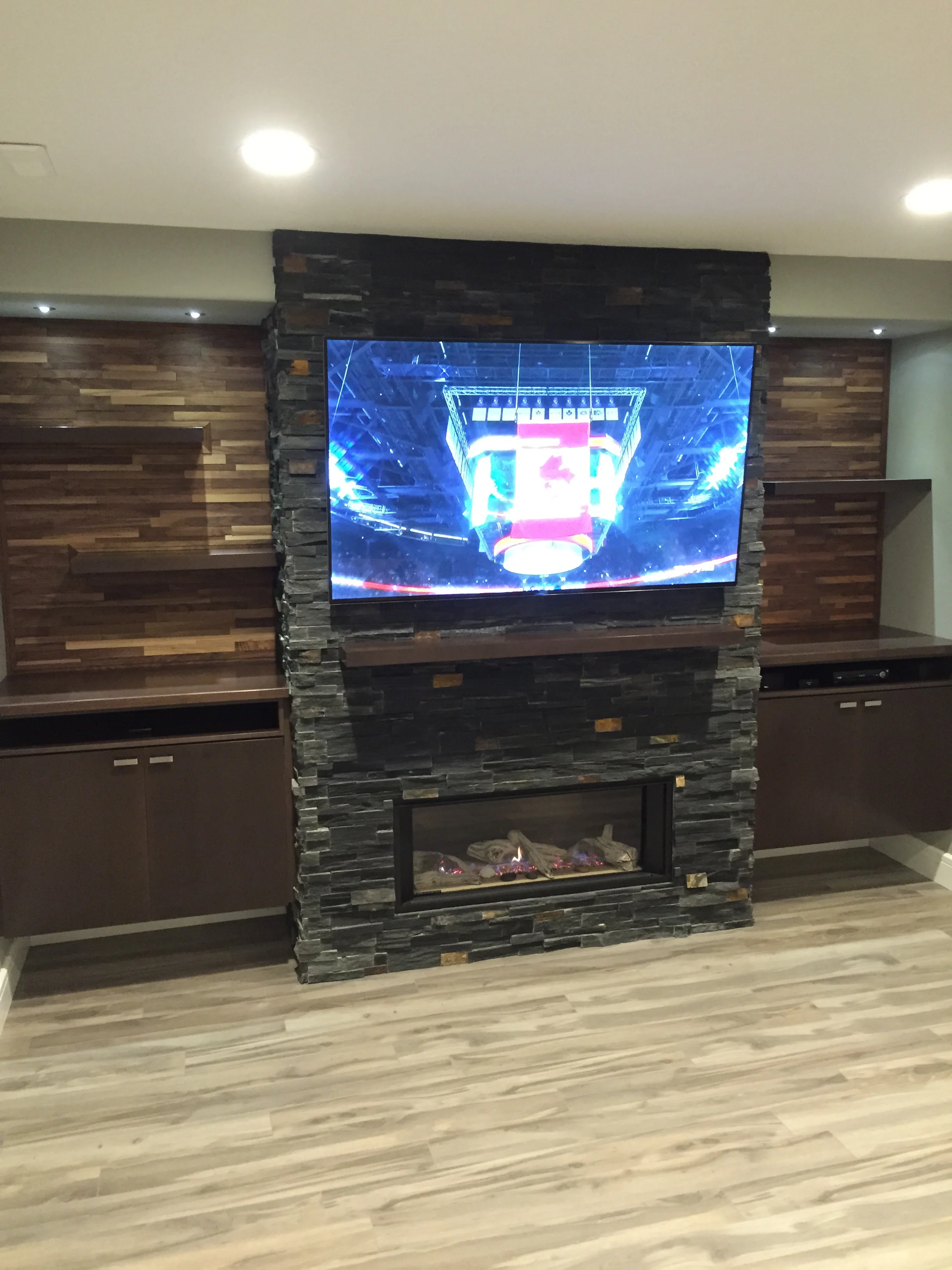 Basement renovation saskatoon, fireplace, flooring, custom shelves, trusted contractor