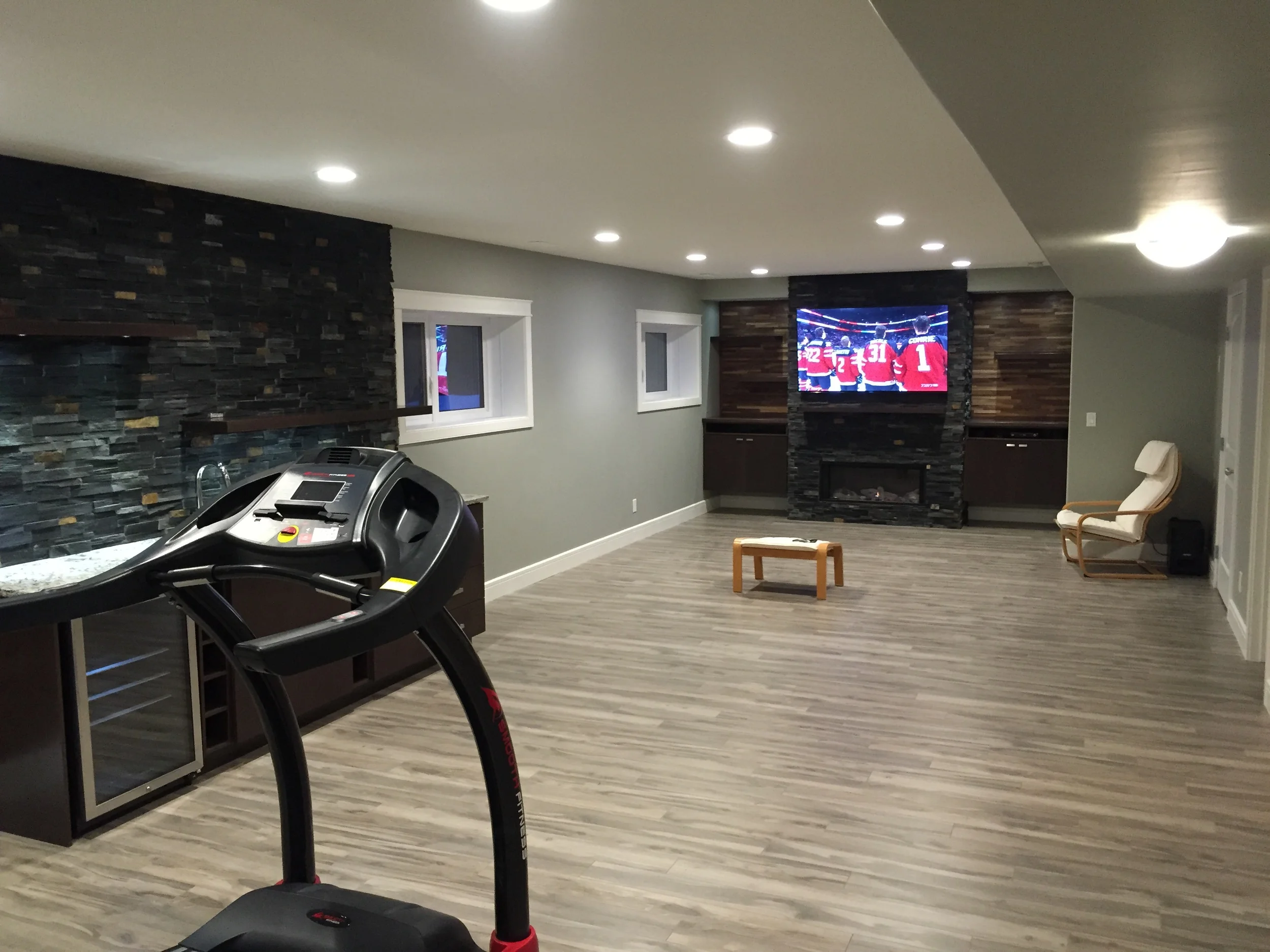 Basement renovation Saskatoon, fireplace,wet bar, stone work, flooring, trusted contractor