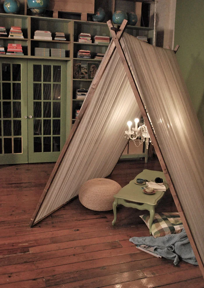 There's never a bad time for a tent fort, especially if rain is involved. And this one is tricked out with a chandelier!? Whatever light source you use, bring a little box or stand of some sort in so you can set up a little tea station in the middle of your soft blankets and pillows (there's never enough). Why not keep it up through the weekend so you can #NetflixAndChill in the comfort of your fort, inside the protection of your home, as it thunders outside.