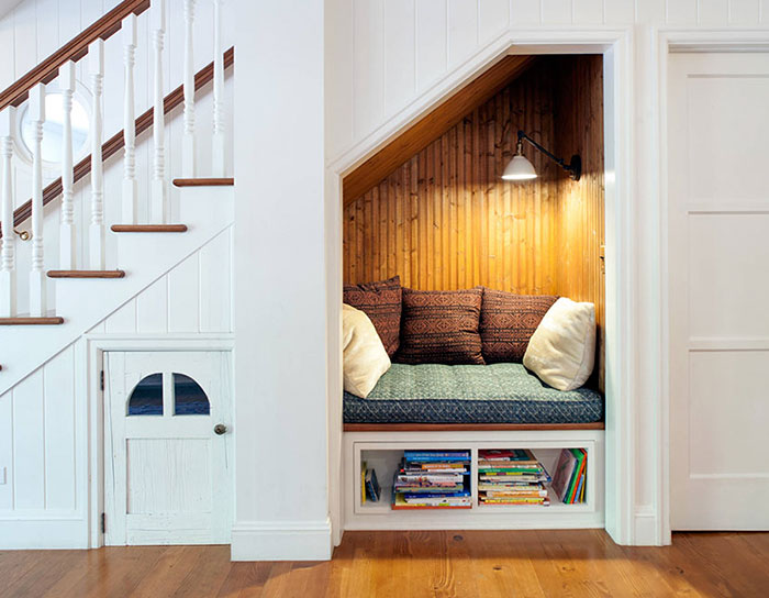 This is a true nook. Being under the stairs isn’t so bad all the time (sorry, Sir Harry Potter), especially when it's as comfy and secluded as this one. But what do you think is behind the door on the left? Surely there isn't a house elf taking up residency...