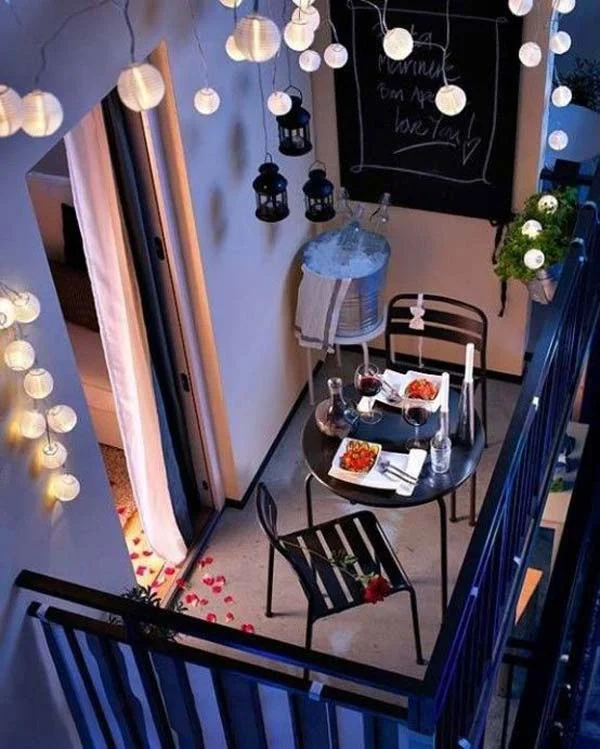How romantic is this balcony! Dress up your small space with some small hanging lanterns and plants to decorate your railing. Simple outdoor furniture is perfect for this space when the colors of love are in the air (*cue the rose petal trail*) and candles are flickering against the burgundy colors of your wine. 