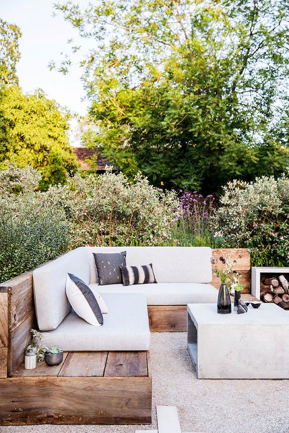 Want to really invest in redecorating your patio? Check this one out. The main table is concrete and goes swimmingly with the rustic wood and grey tones of the couch. Depending on your yard space, surround your patio deck area with foliage and greenery of all sorts. Add a couple old glass bottles and dishes for flowers and other table accessories (succulents are a great option). Greens against browns and greys = nature love, right in your very home.