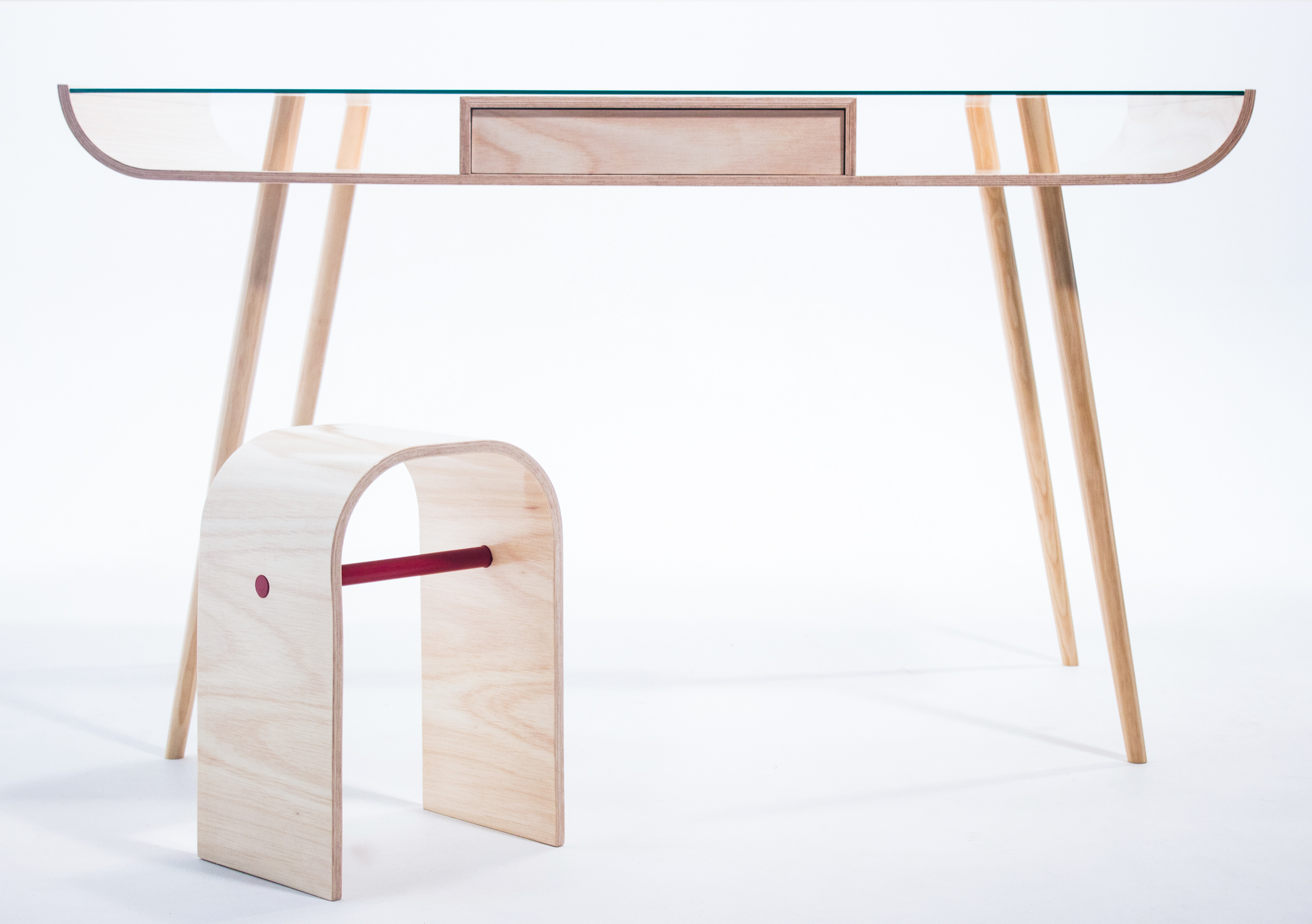 Leveillä is a table derived from the bent plywood techniques of the 1930’s and 1940’s craftsmen. With this table the aim was to explore how the designers were able to craft objects of a timeless and beautiful nature. Leveillä was hand made in a cold press lamination. Using CNC technology to create the mold allowed for an accuracy that translates throughout the whole table. The glass sheet to slips into place yet is held firm enough to not require fittings. This has allowed the design to be kept clean and simple in its overall form. 