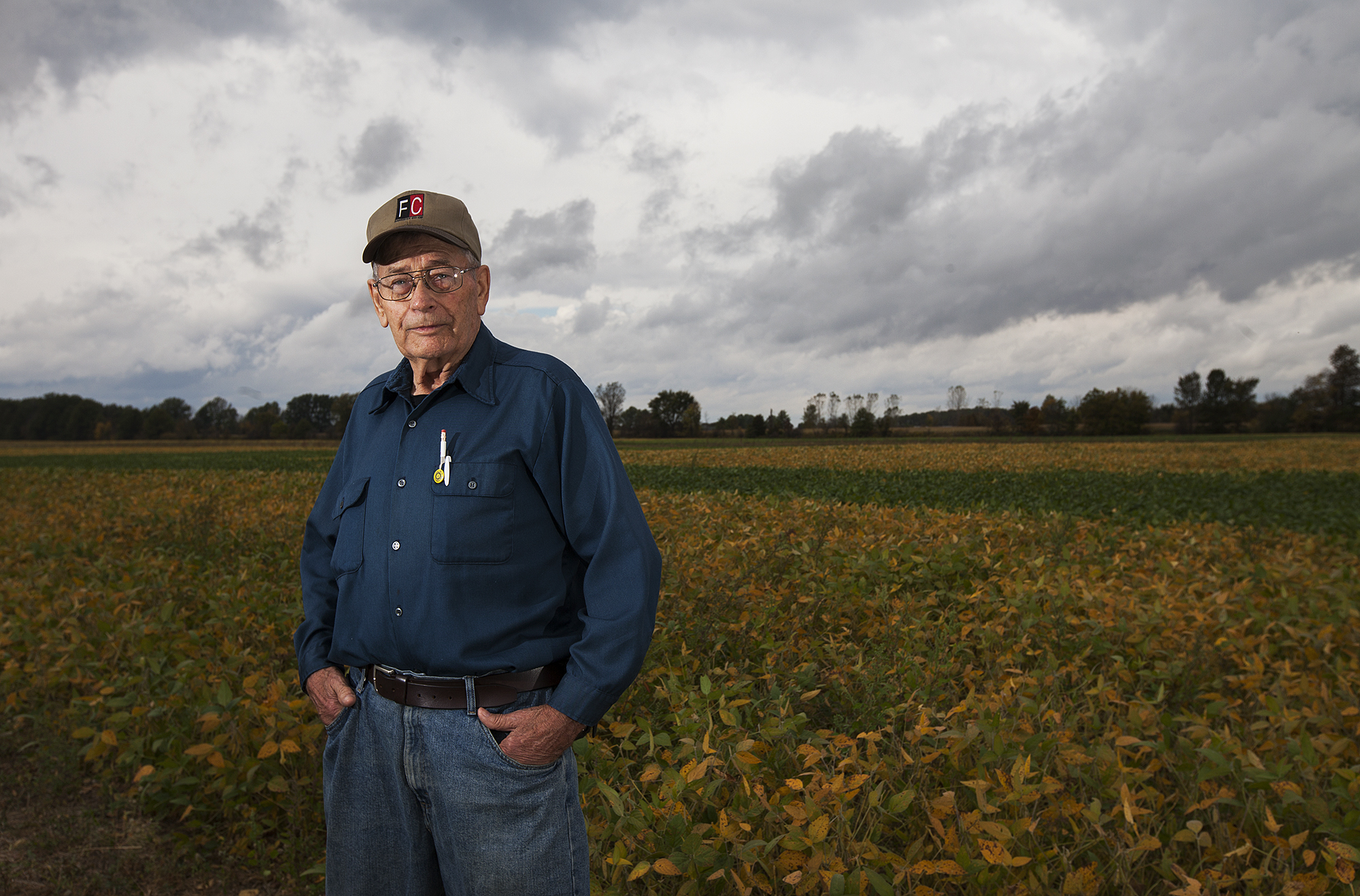 Bill Cox poses for a portrait in front of his field of soy beans outside of his Ostrander home, Friday, October 3, 2014.