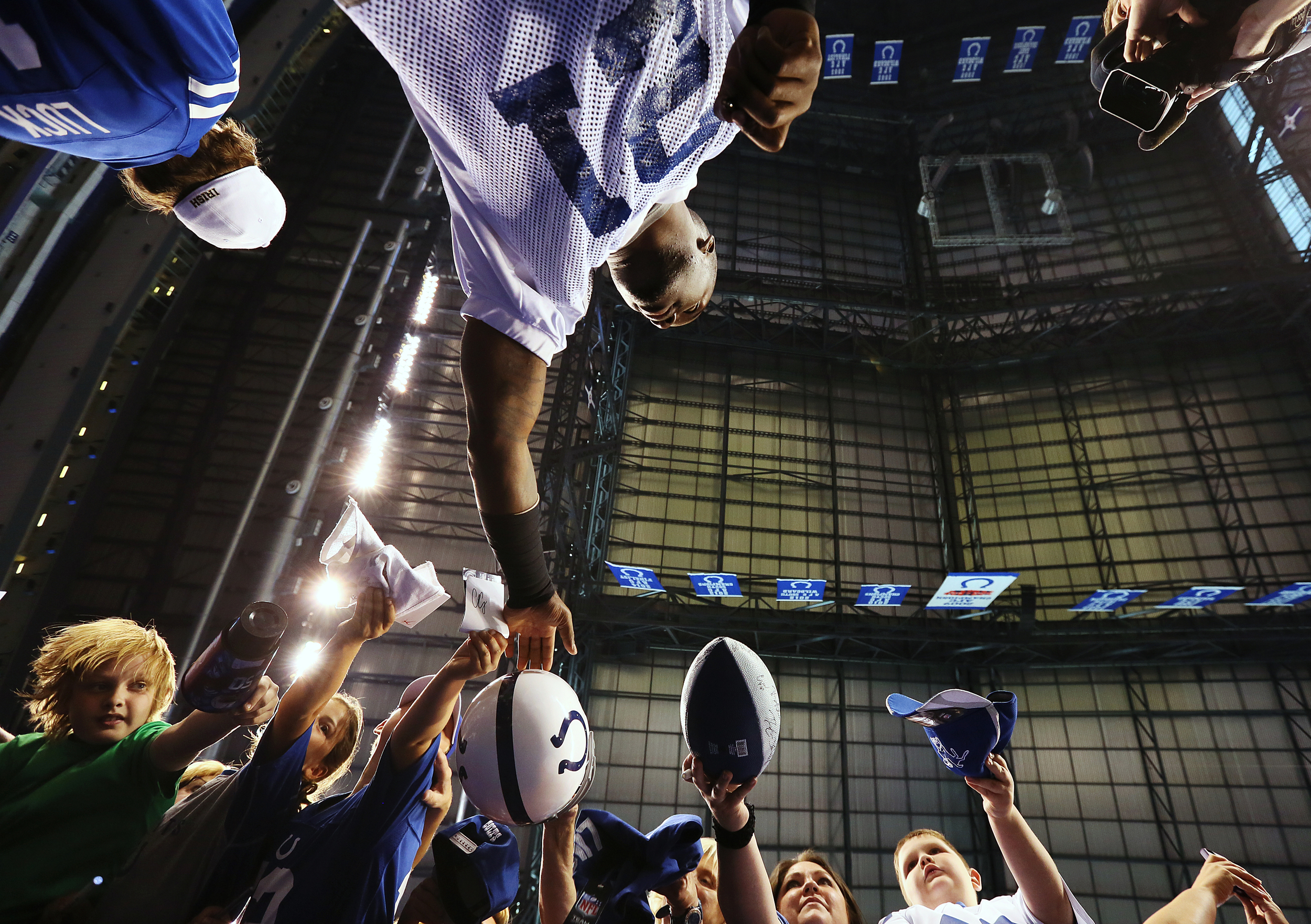 Cornerback Vontae Davis (21) signs autographs for fans before public practice at the annual Indianapolis Colts mini-camp and fan open house, Lucas Oil Stadium, Wednesday, June 10, 2015, Indianapolis, Ind.
