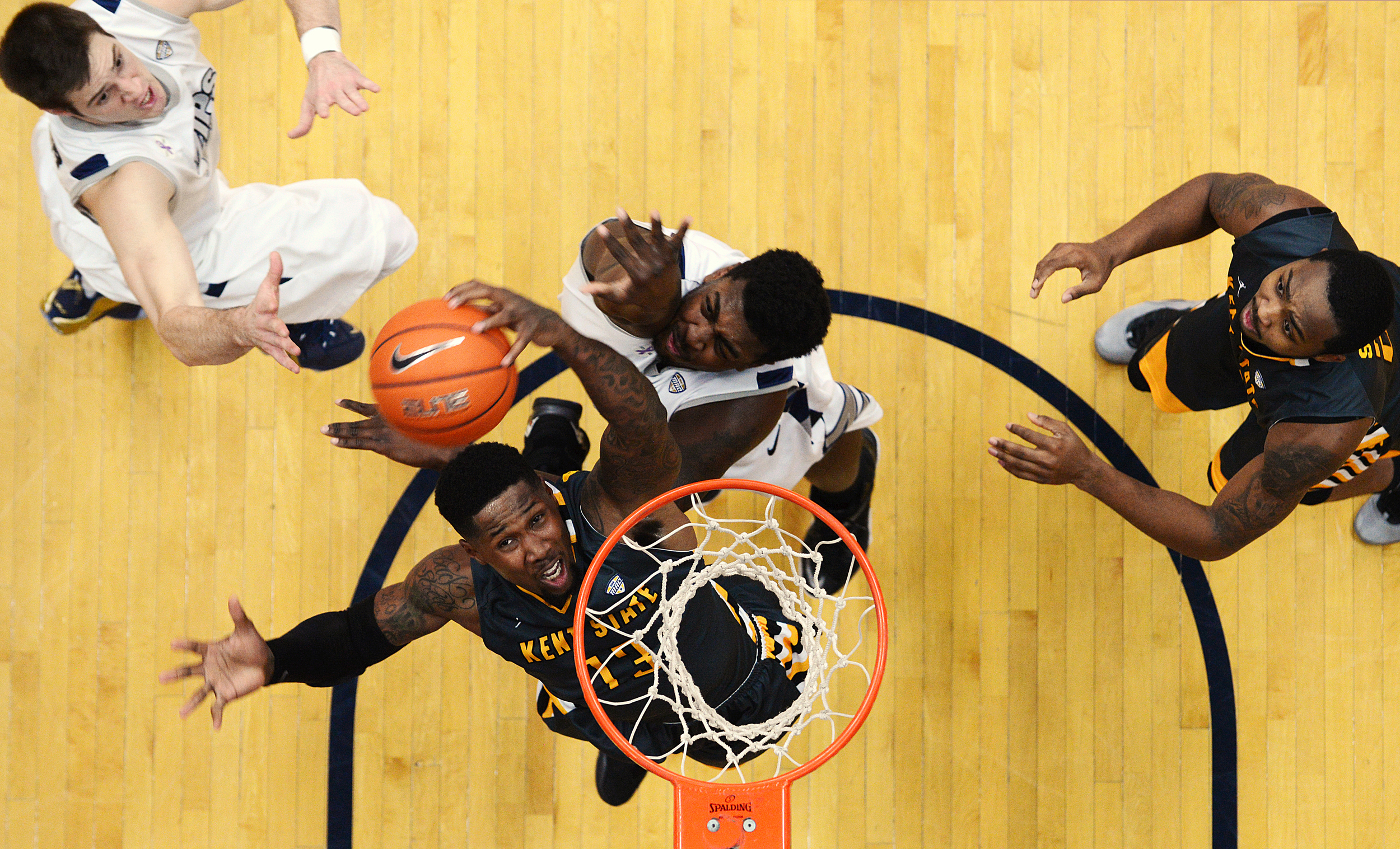 (Center) Kent State red shirt senior guard Derek Jackson takes a shot, under defense from University of Akron sophomore center Isaiah Johnson at the James A. Rhodes Arena in Akron, Ohio, Tuesday, February 10, 2015. Kent lost to Akron, 61-52.
