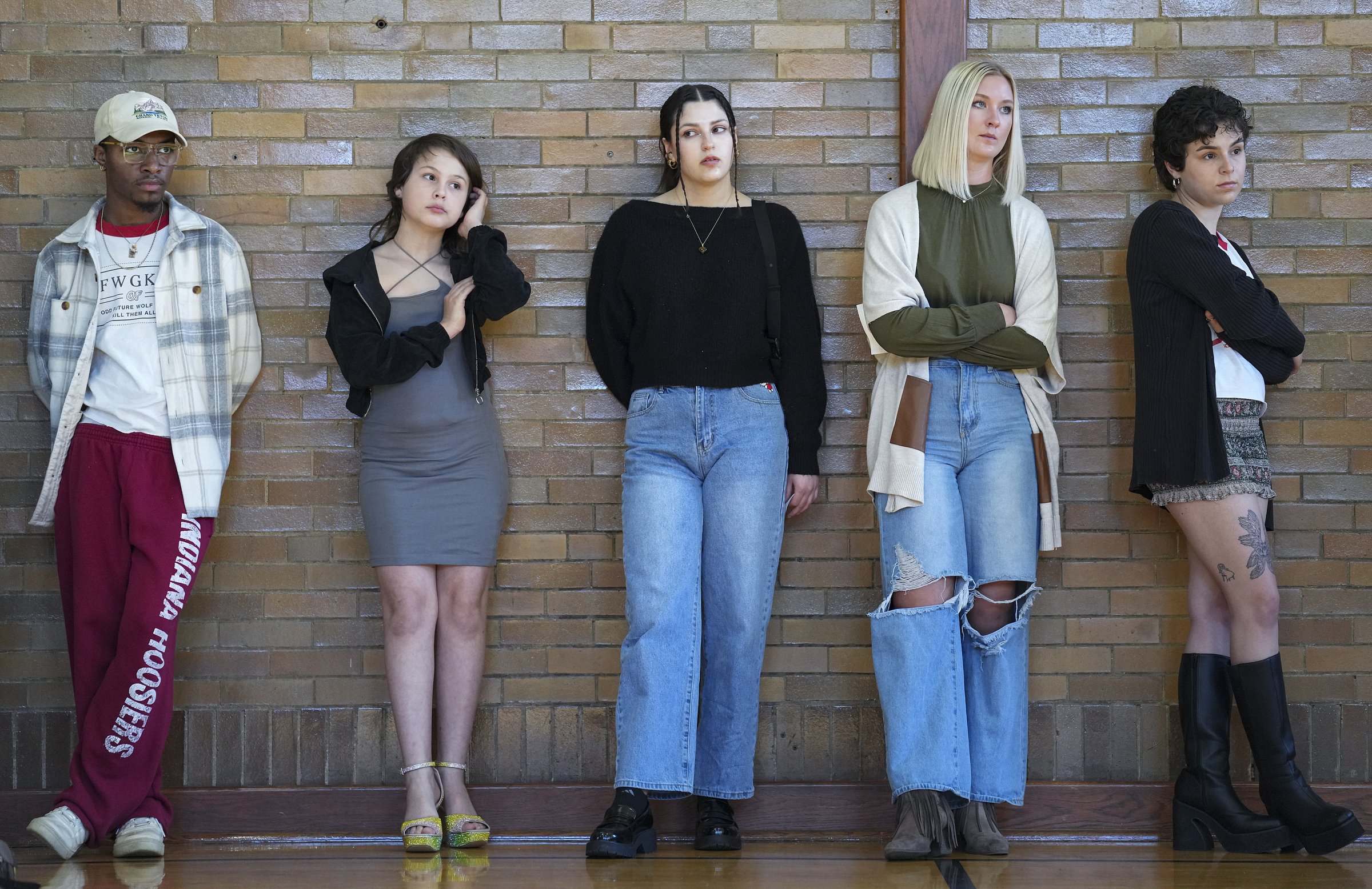  Kirin Clawson, second from left, waits in line to practice her runway walk Sunday, April 2, 2023, during rehearsal for the Trashion Refashion show in Bloomington, Ind. For the show, Clawson would model an outfit designed by Jeanne Smith. "We need tr