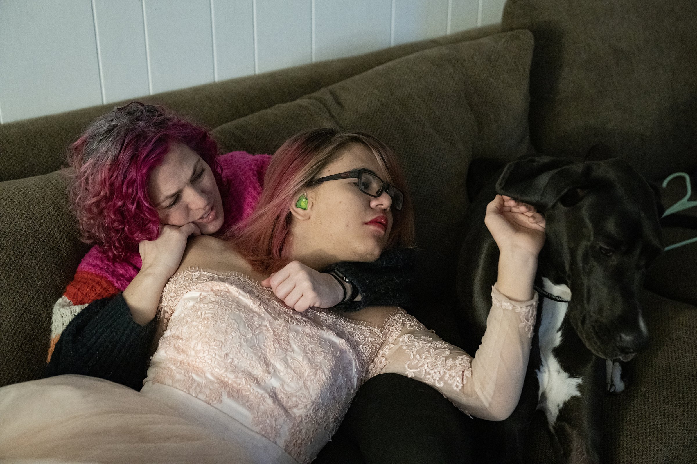  Chrissy Honig, her 14-year-old son Oliver and their dog Trixie sit together on the couch Thursday, Dec. 8, 2022, at his home in Westfield, Ind. "I just hope that he's always confident enough to just be who he is," Chrissy said. "And even though he c