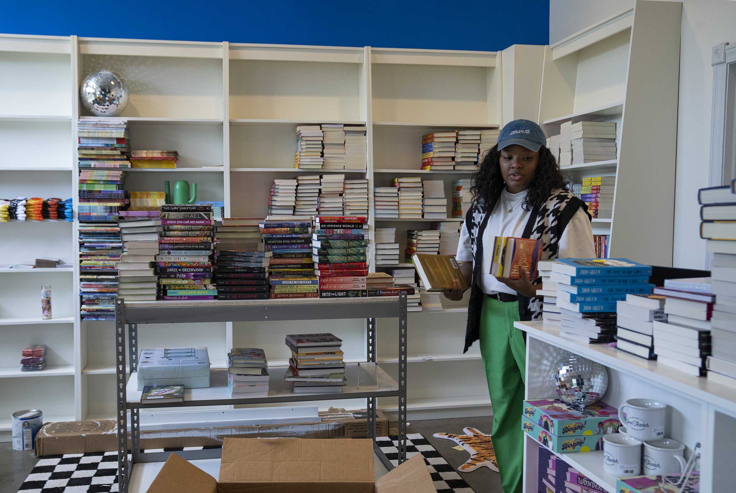  Leah Johnson unpacks books at her bookstore, Loudmouth Books, on Tuesday, Aug. 29, 2023, in Indianapolis. Johnson, an author and owner of the shop, will sell books that have been banned by government and school systems, and books written by and for 