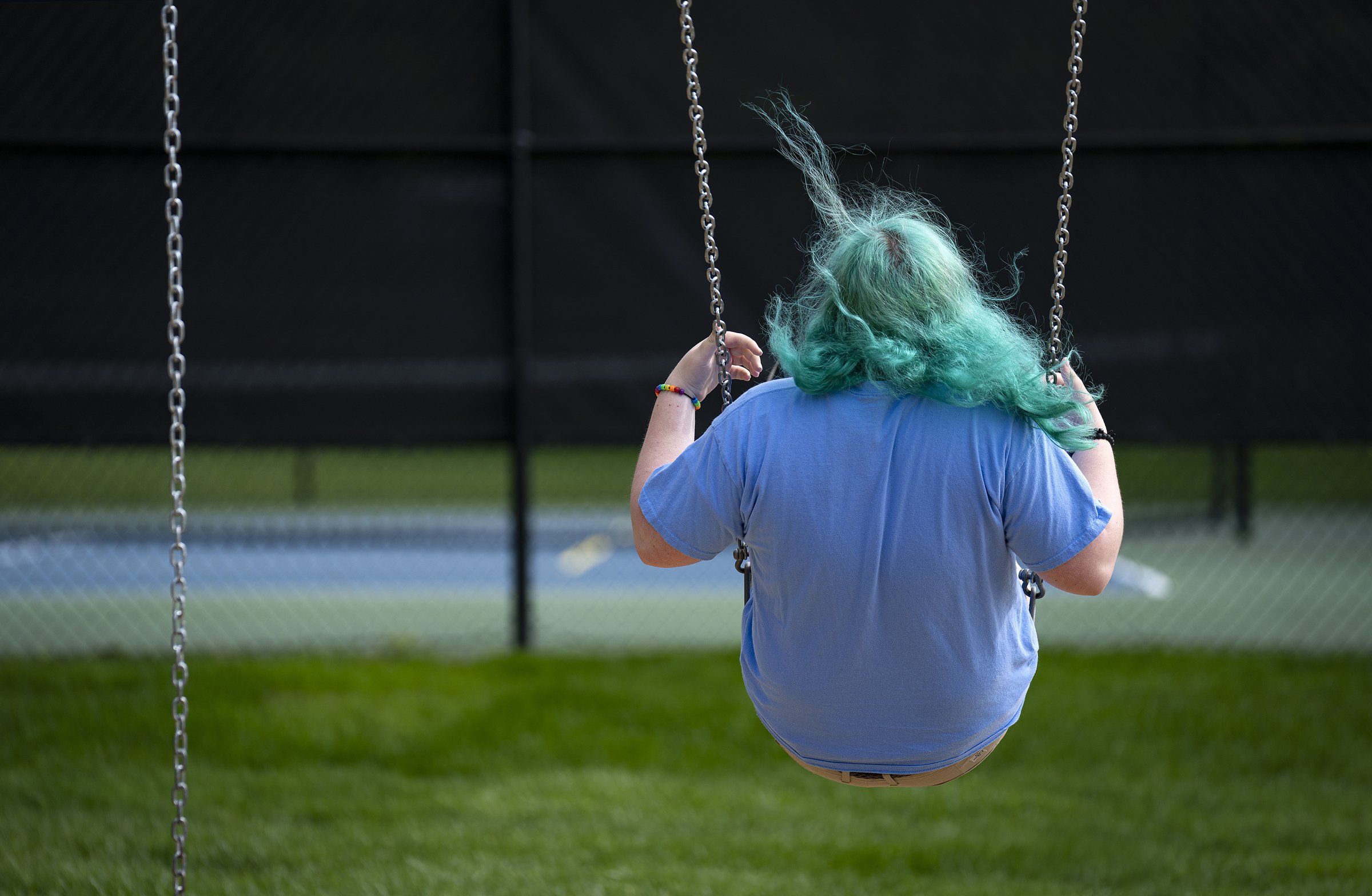  A 16-year-old transgender girl swings in Indianapolis on Thursday, May 11, 2023. She asked to remain anonymous due to safety and privacy concerns. Her family has been rooted in Indianapolis for decades but is considering leaving the state due to rec