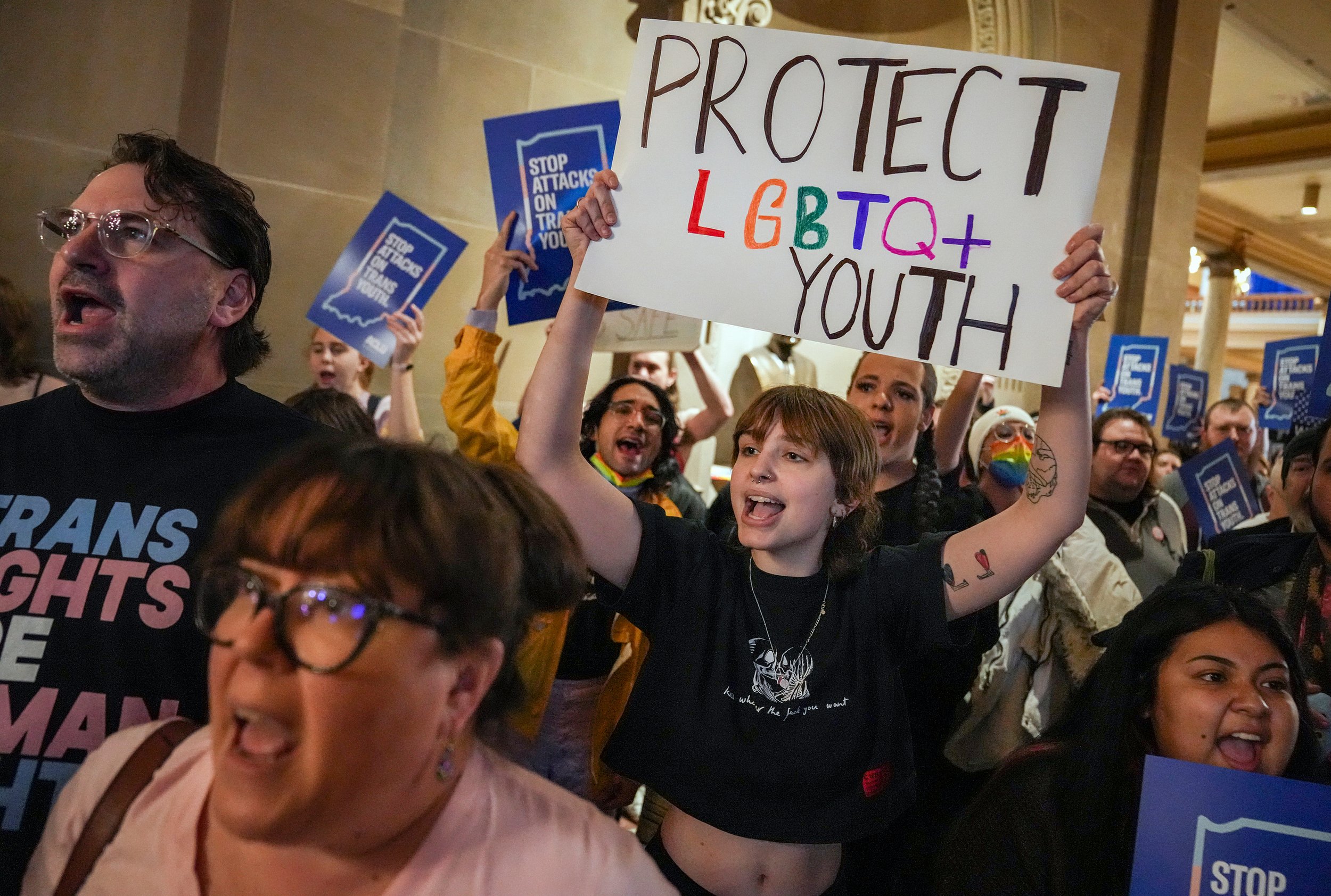  Eliza Housman, center, and others protest outside the Indiana Senate Chamber on Wednesday, Feb. 22, 2023, as the Senate Health and Provider Services Committee hears SB 480 at the Statehouse in Indianapolis. The bill, which passed committee 8-3, woul