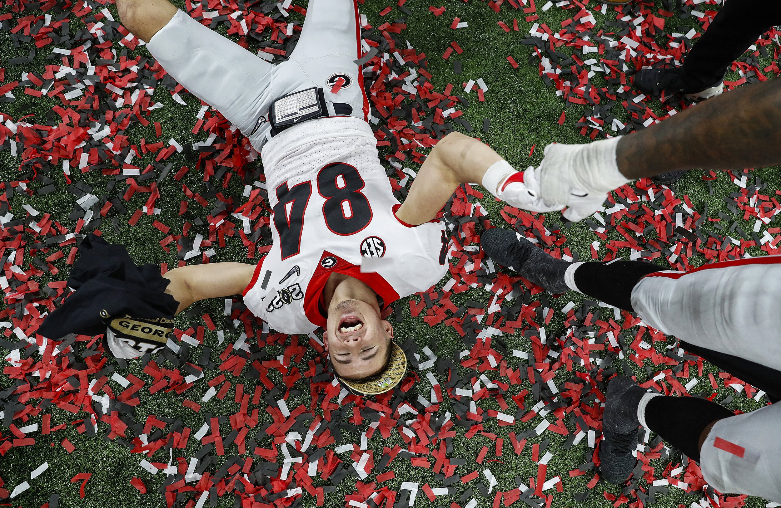 Georgia Bulldogs wide receiver Ladd McConkey (84) lays in confetti after winning the College Football Playoff National Championship on Monday, Jan. 10, 2022, at Lucas Oil Stadium in Indianapolis. The Georgia Bulldogs defeated the Alabama Crimson Tid