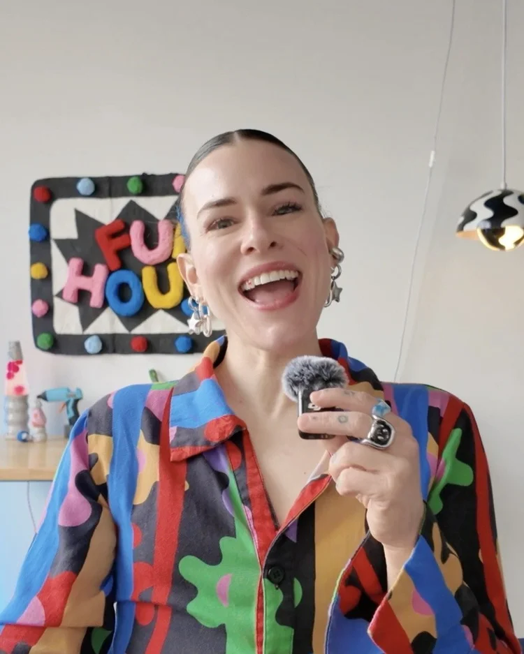 Meg laughing in a bright patterned shirt