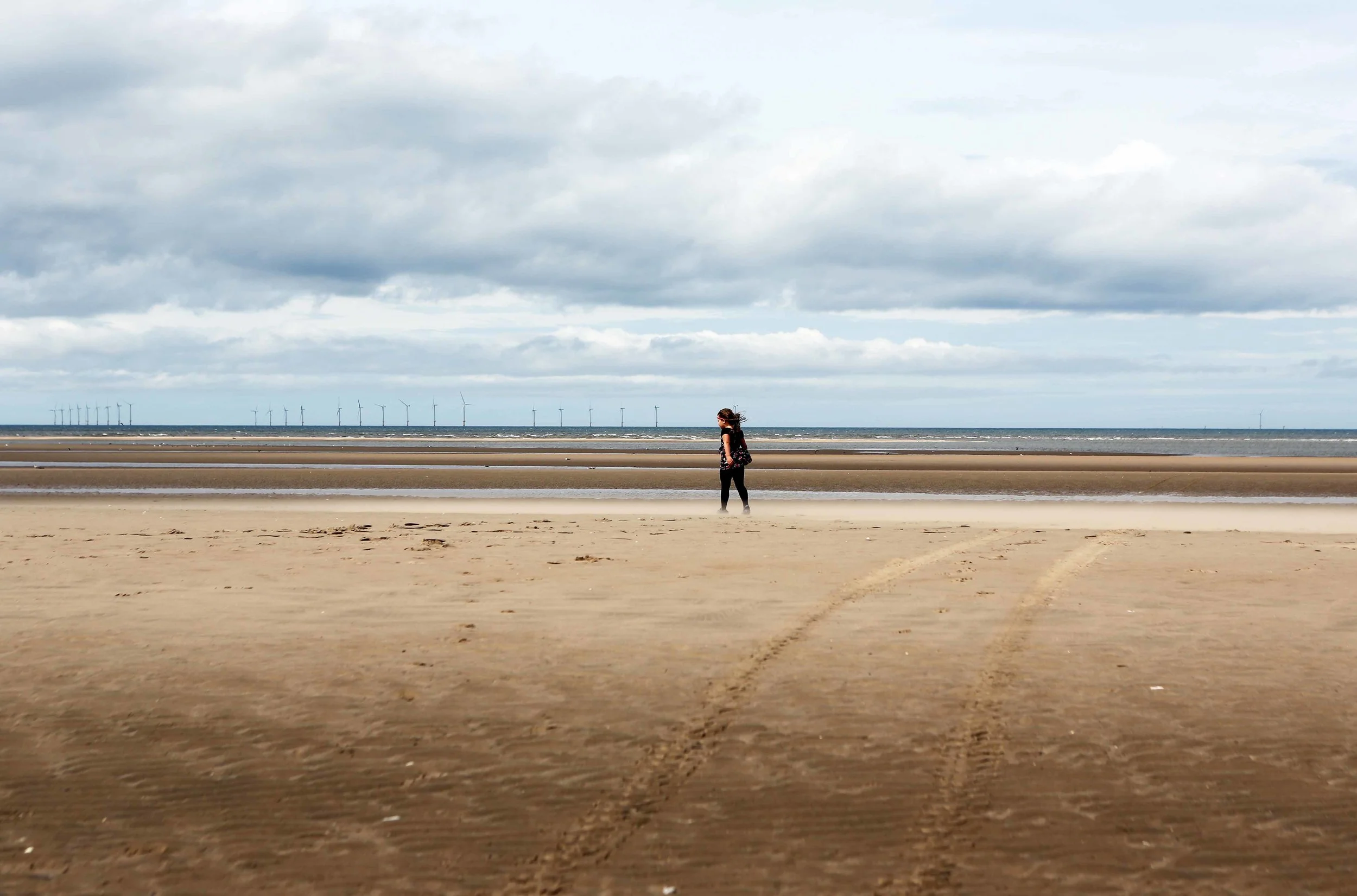 Rhyl girl in windy sand + windm lavo 8.13.jpg