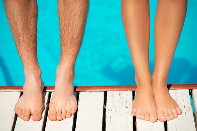 couple standing on the edge of a pool.jpg