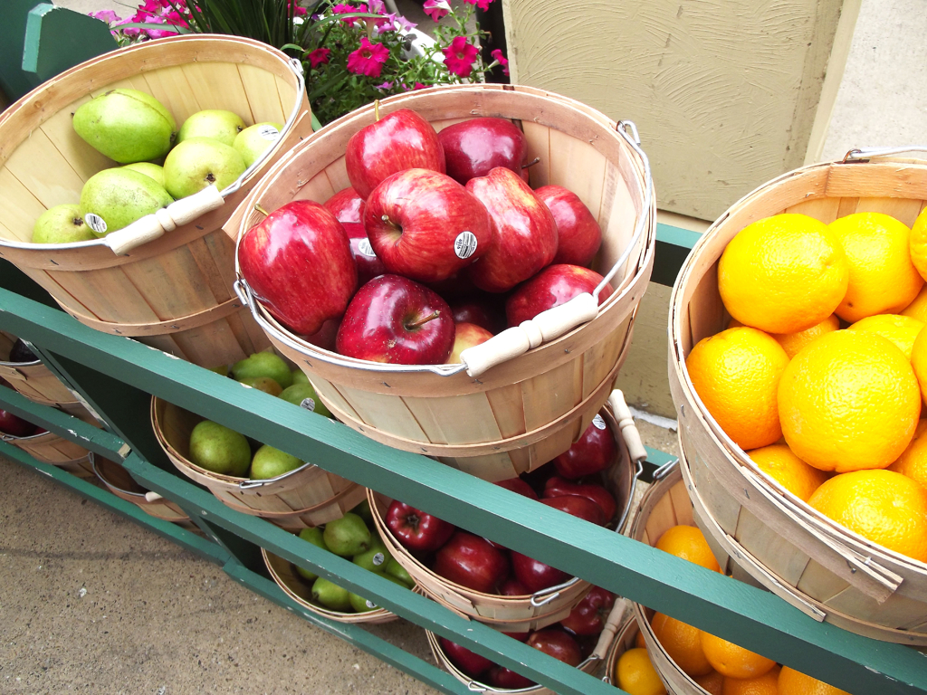 An assortment of fruit to choose from in bushels.