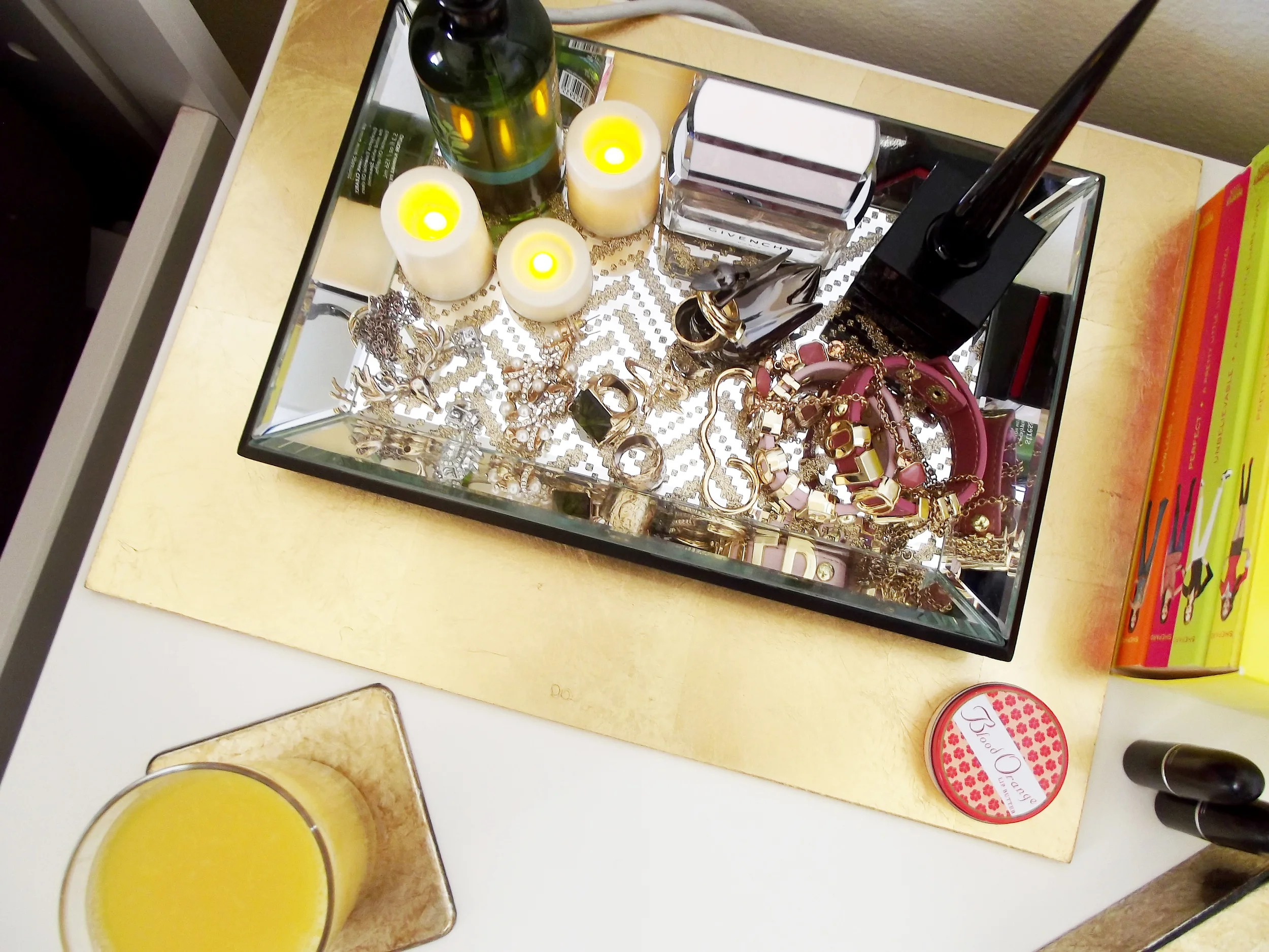 Before I added this chevron tray to the mix, my jewelry was just lying across the hatch of my desk which was probably the worst place for it. I found this mirrored chevron tray ($14.99 regular discounted price) and had to get it! I also added a few flameless candles ($6.00, yellow-tag) and placed the tray on this gold fiberboard placemat ($2.00, yellow-tag).
