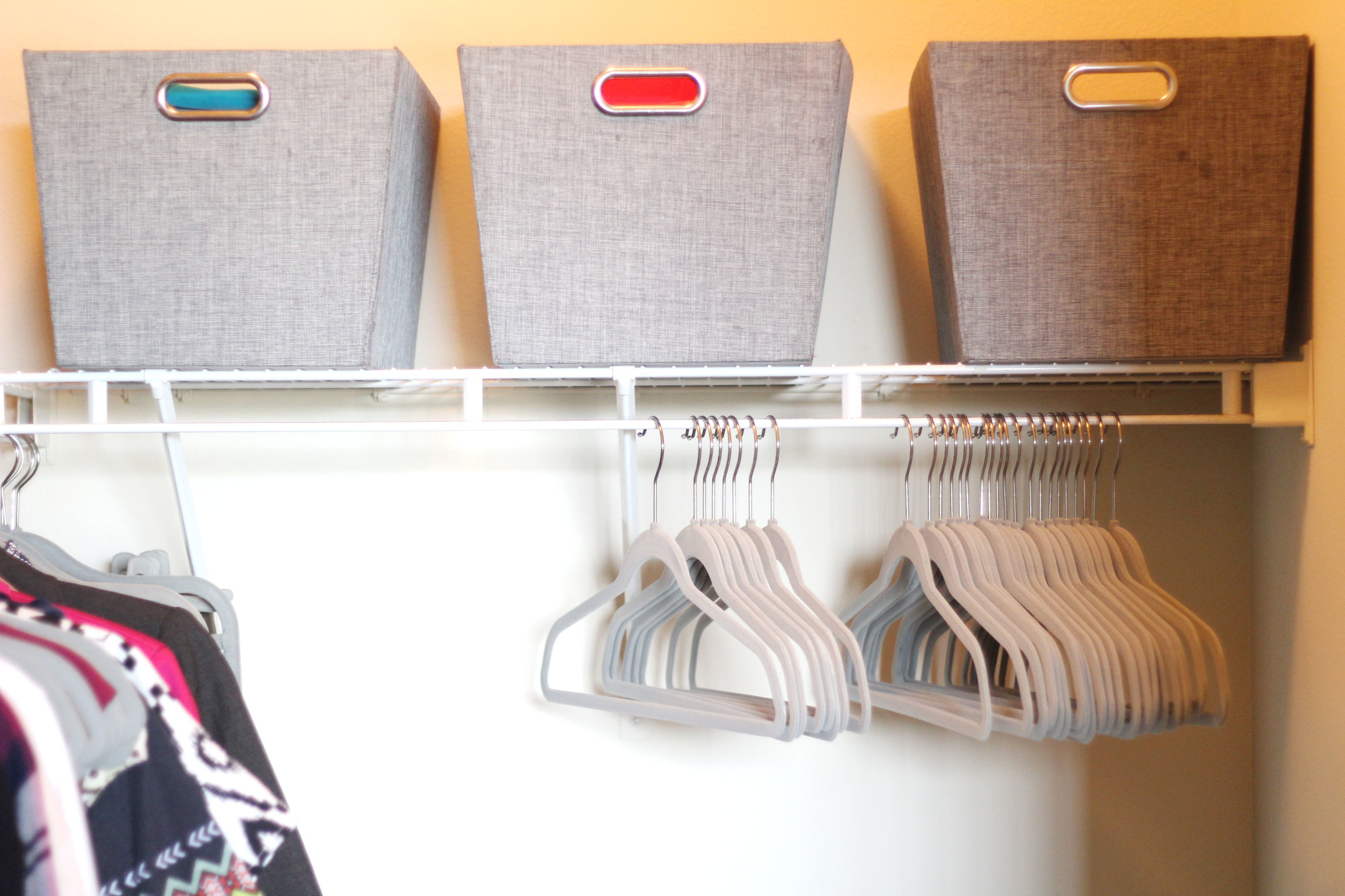 Three large shelf storage totes in grey ($12.99 each); Velvet hangers in light grey ($19.99 per 50-pack)