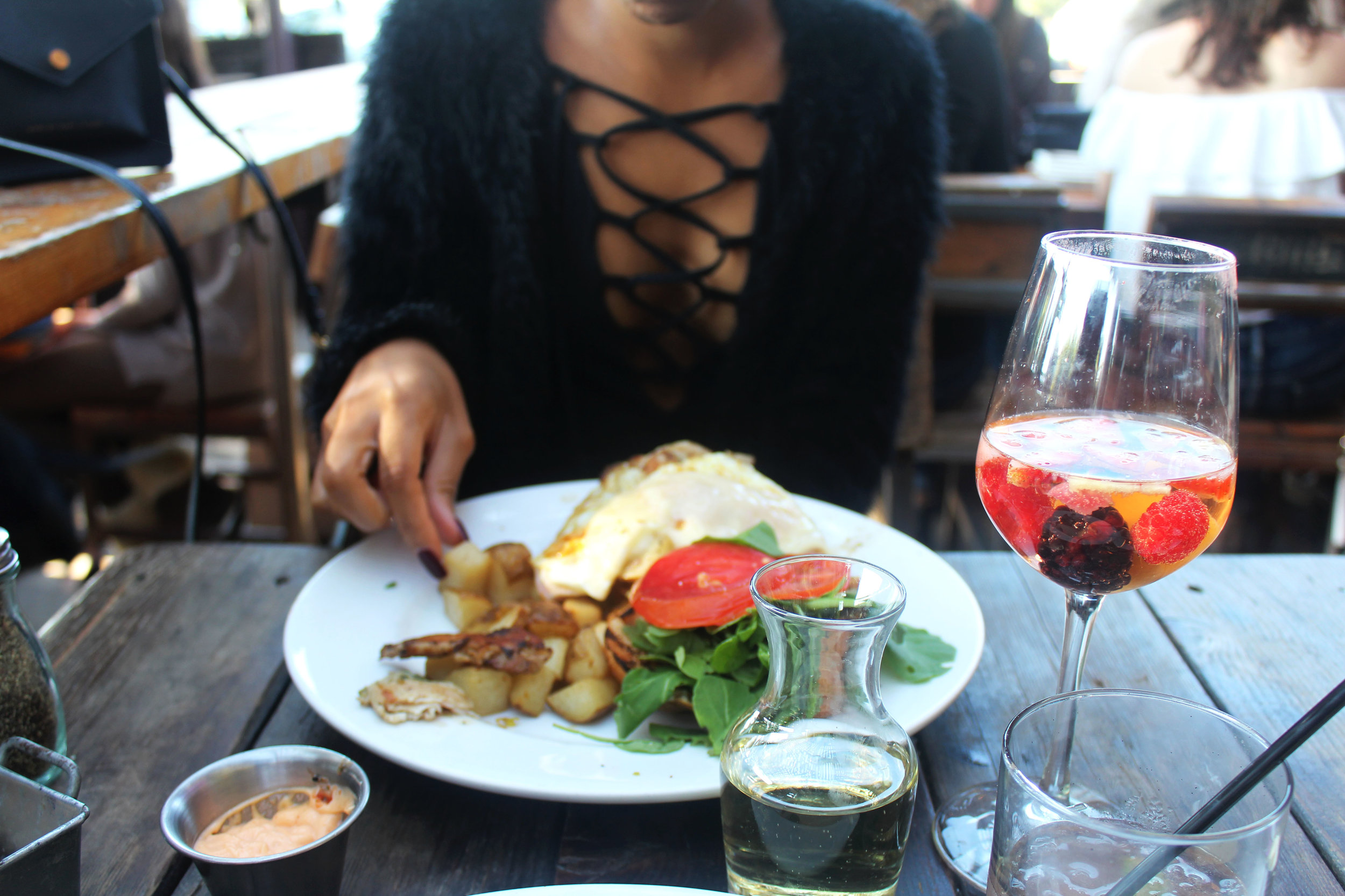 Kelley eating her Porchetta Egg Sandwich