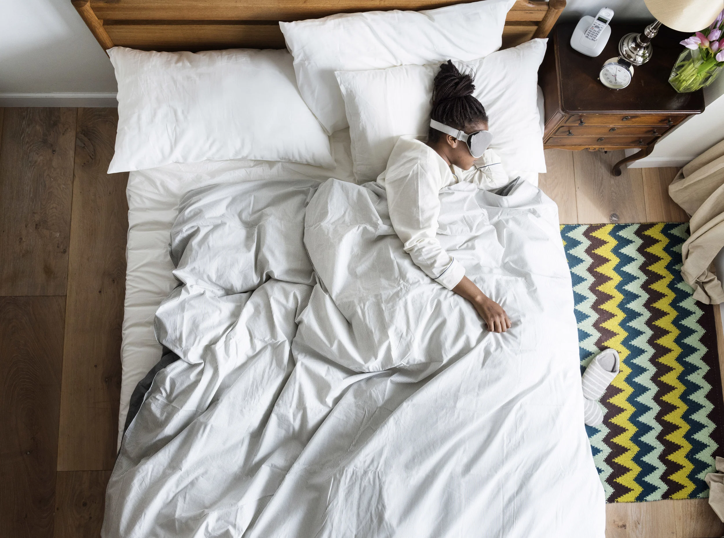african-american-woman-on-bed-sleeping-with-an-PAG298L.jpg
