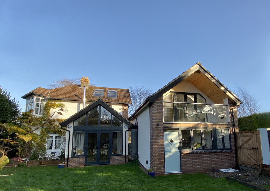 Coach house with glass link to kitchen extension