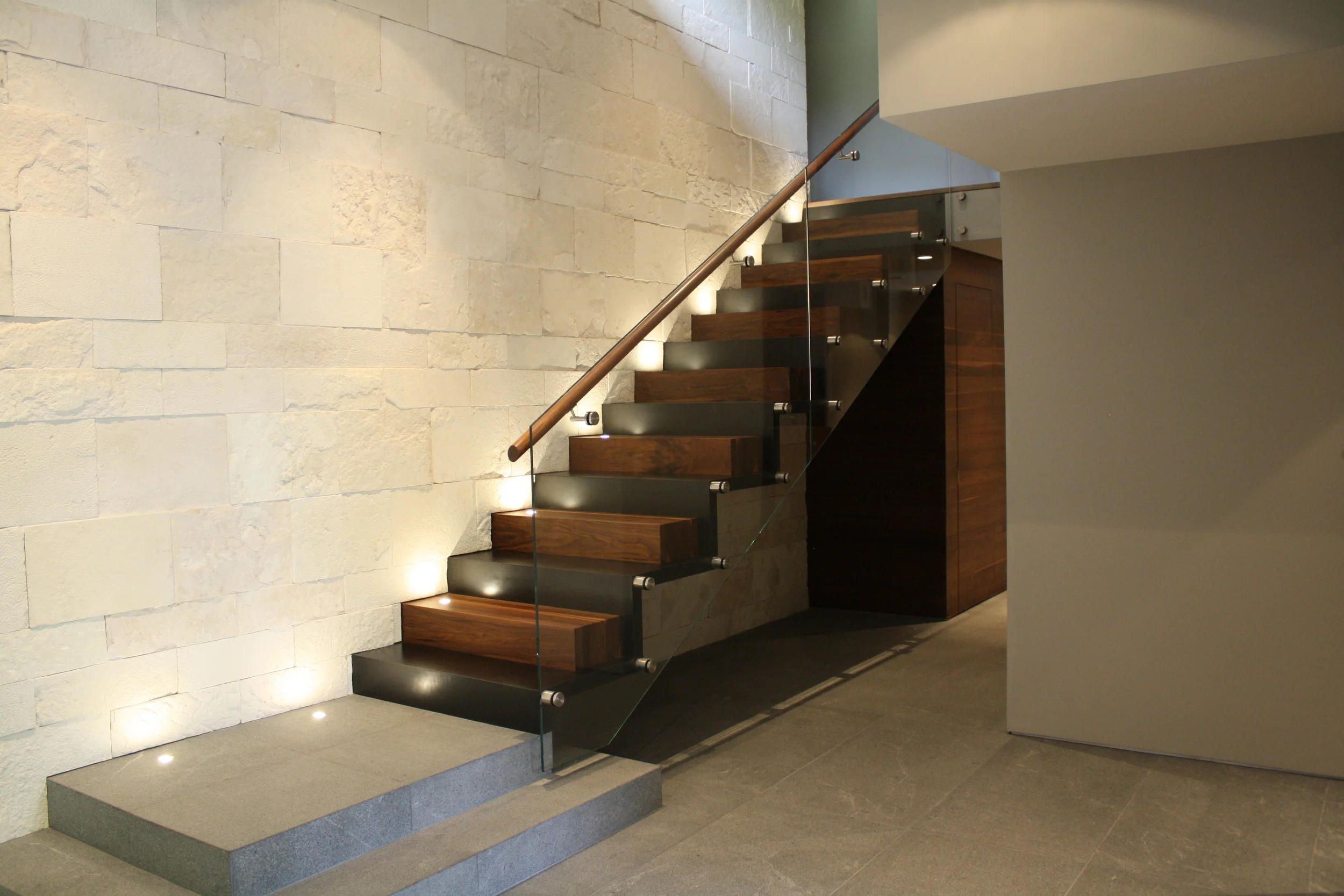 Stairs - featuring stone, steel, solid Walnut, glass and integrated lighting