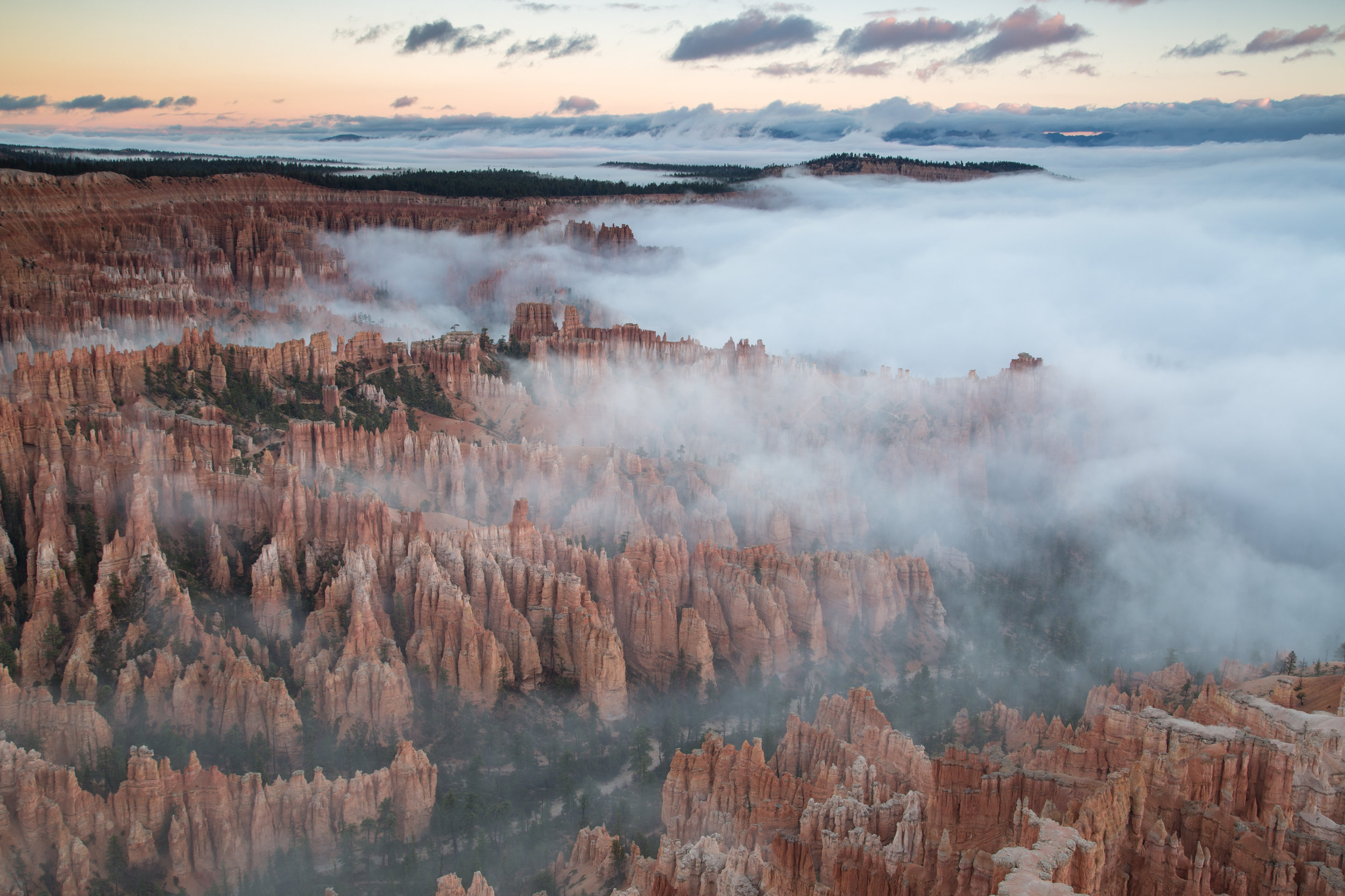 Bryce National Park with Low Fog and Clouds at Dawn