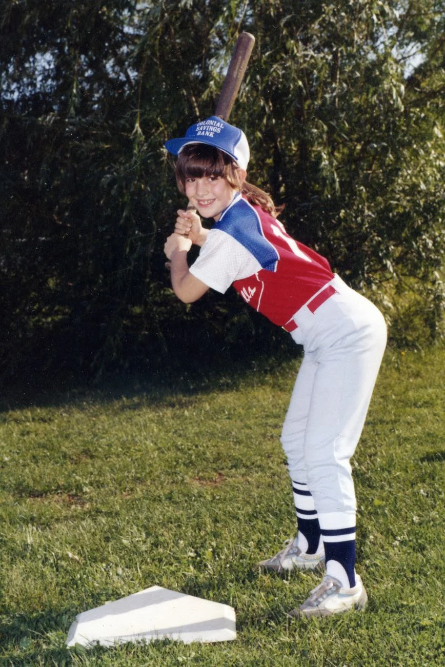Poised and goal-oriented, a ten year old relies on her movement habits to slug the ball out of the park.