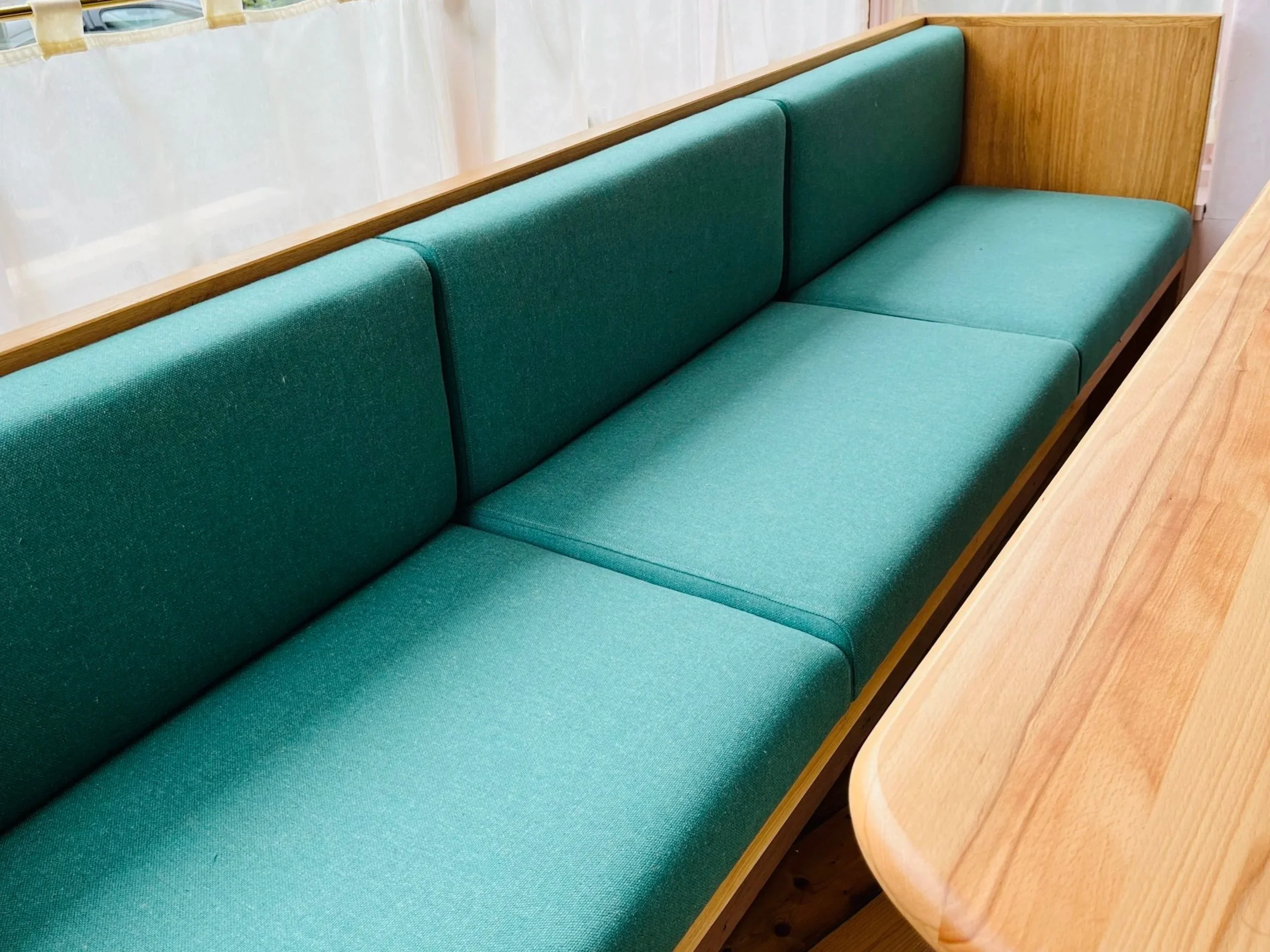 We purposefully divided the banquette into separate sections for longevity. In the event it’s damaged/soiled (likely for a busy cafe!) it’s easier and more cost effective to replace a section than reupholstering the whole unit.