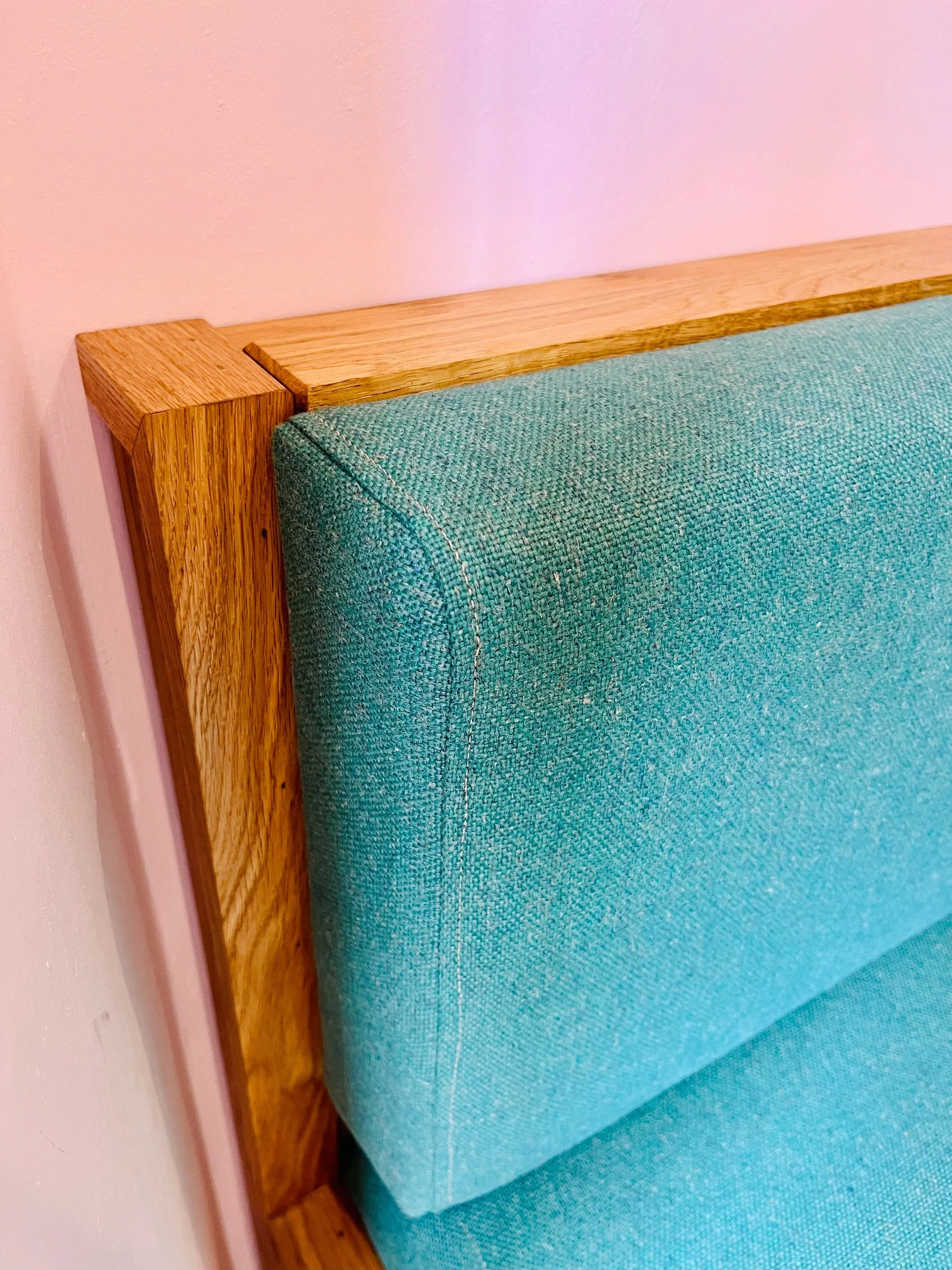 Upholstered in a woven fabric of blended wool and plant-based fibres ('Main Line Flax' in Harrow by Camira). A sustainable choice aligned with the values and overall aesthetic of this suburban coffee shop.