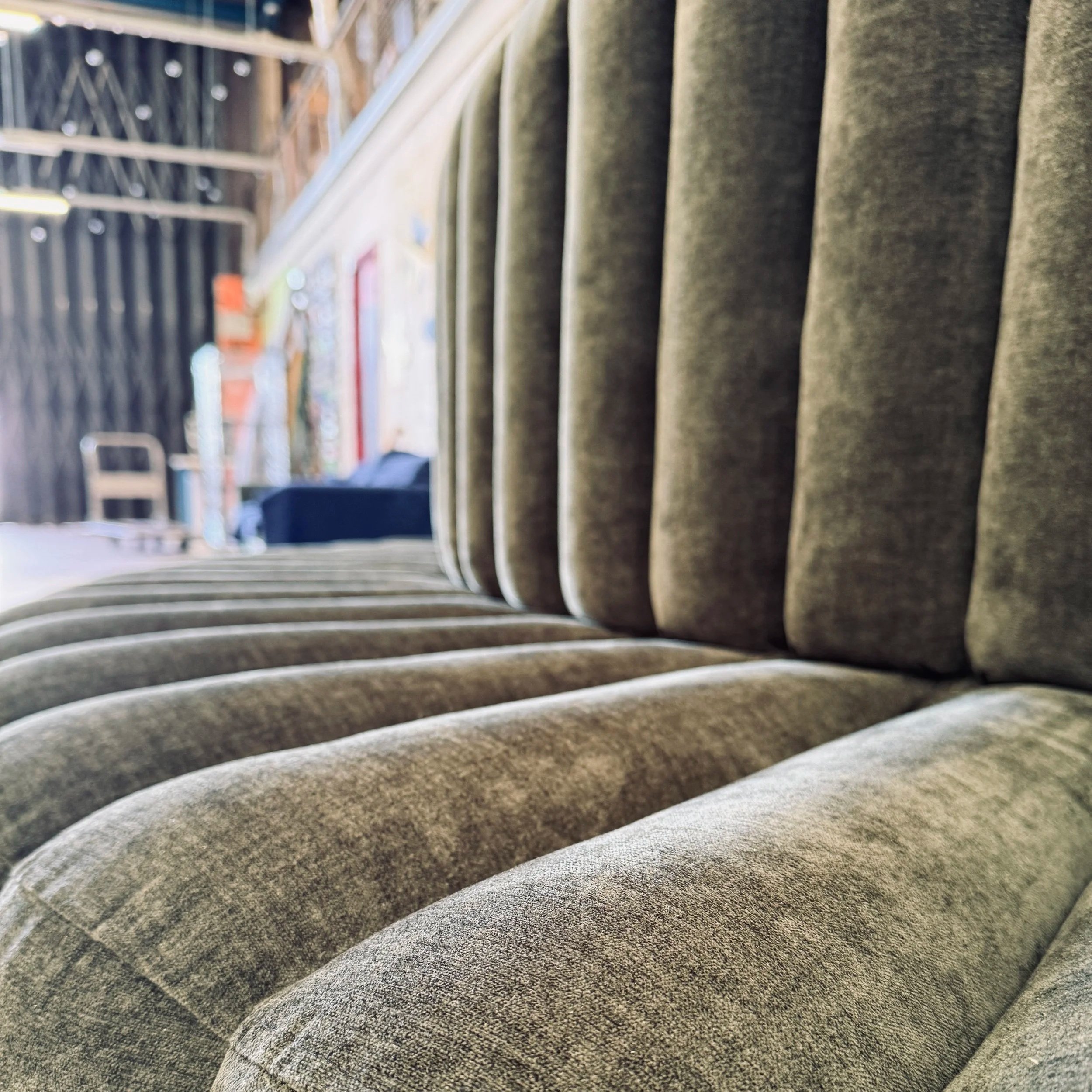 Upholstered in a commercial grade chenille fabric for durability with a slightly distressed look.