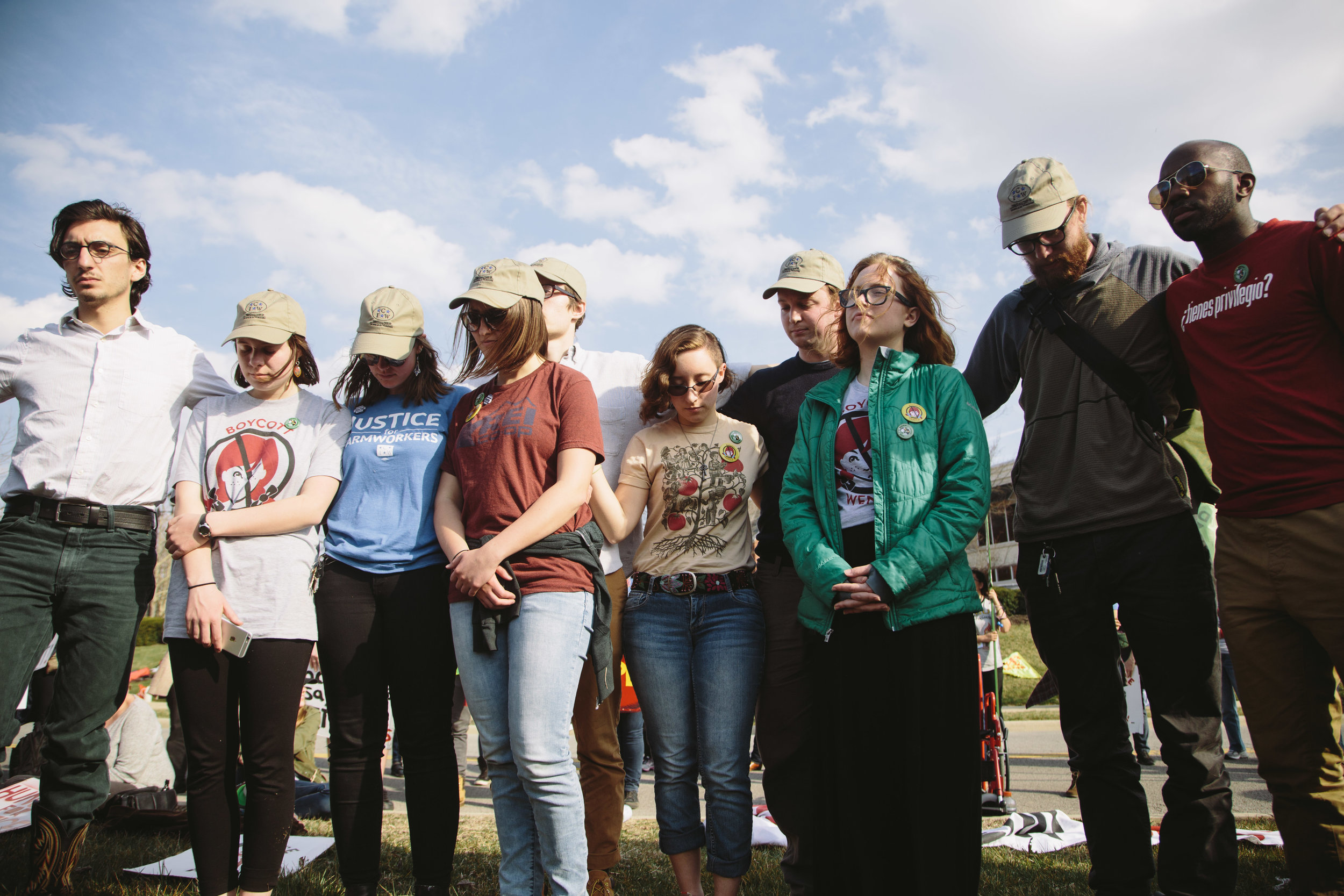  Alex Clemetson, a student at the Methodist Theological School in Ohio (FAR RIGHT), joins the OSU student fasters with whom MTSO students fasted in solidarity this week, after leading a prayer for farmworkers and allies present at the vigil 