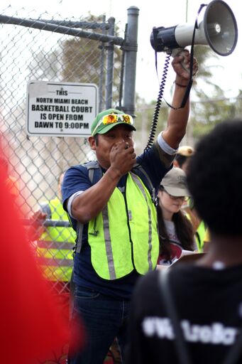 darinel megaphone announcing to crowd.jpeg