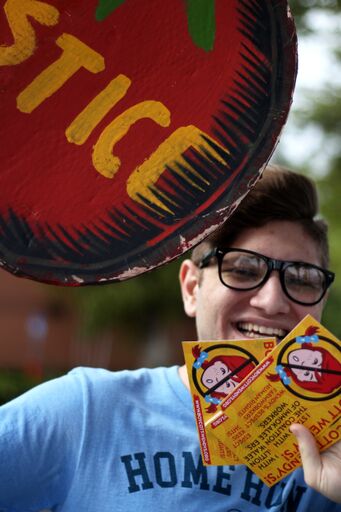 student smiling with flyers.jpeg