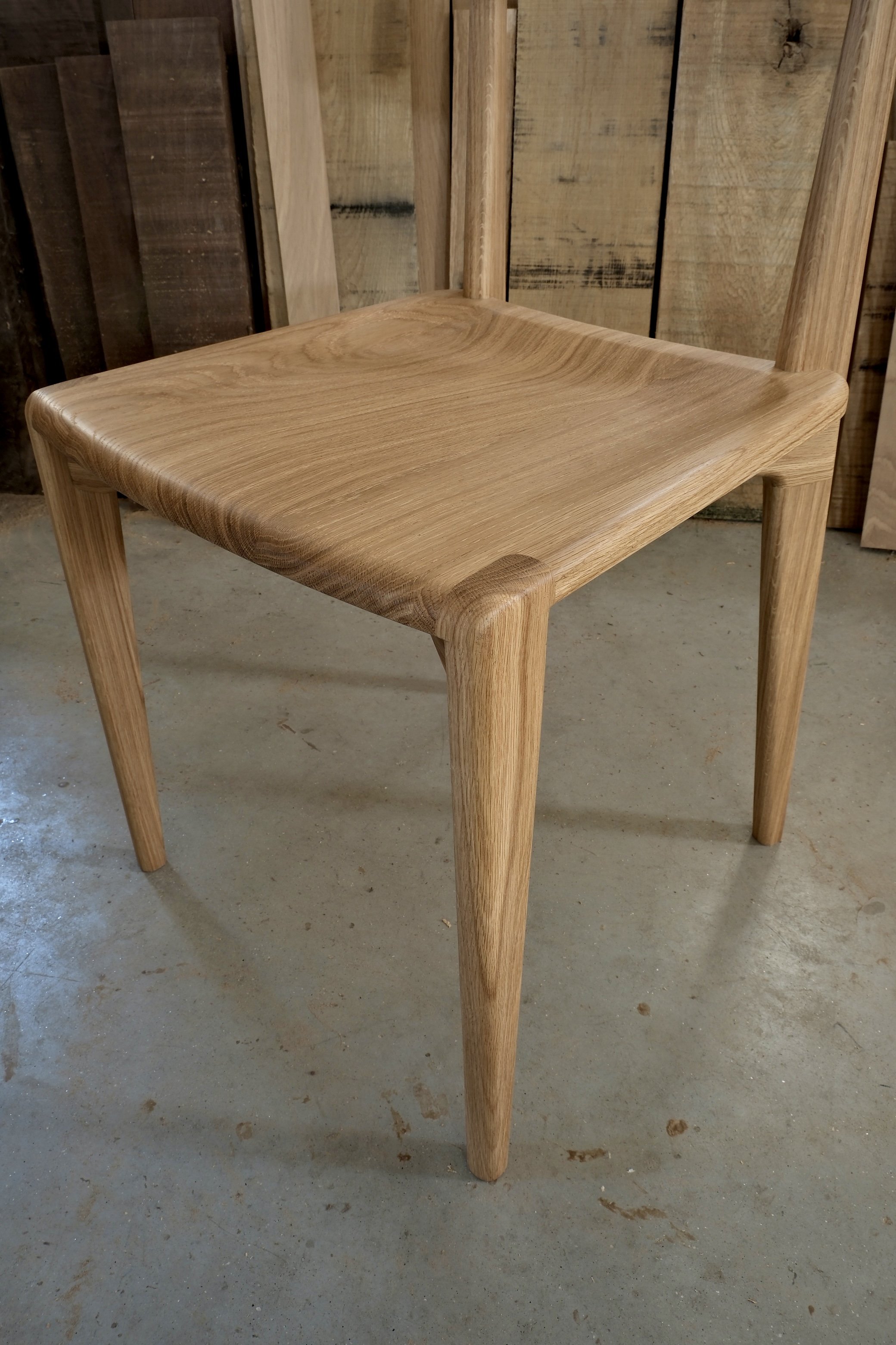 durham chair white oak cutoff background front leg detail.jpg
