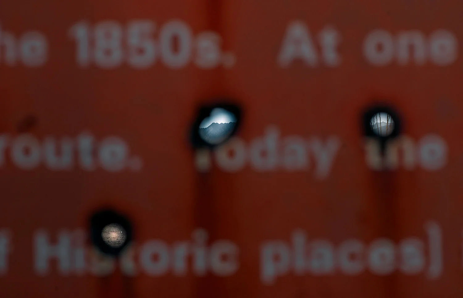Sign explaining the history of the Camino del Diablo, with bullet holes, 2013