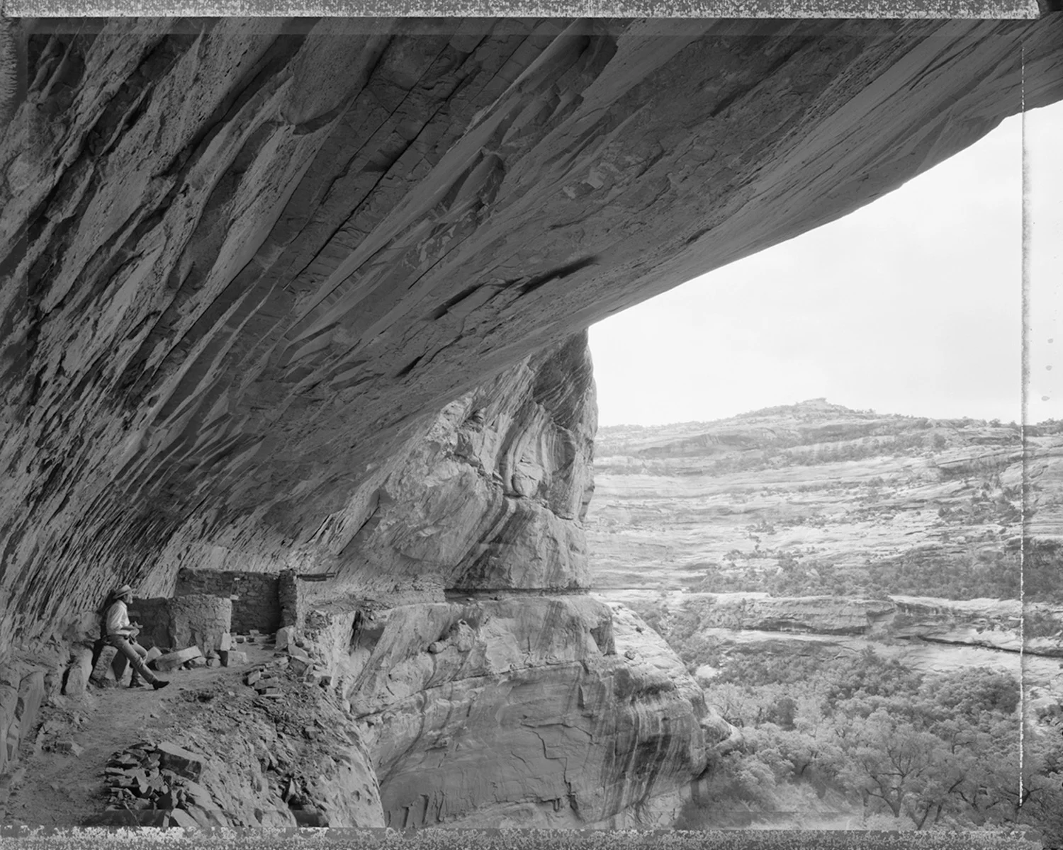 Ed Abbey taking notes in Turkey Pen ruins, Grand Gulch, Utah, 1988