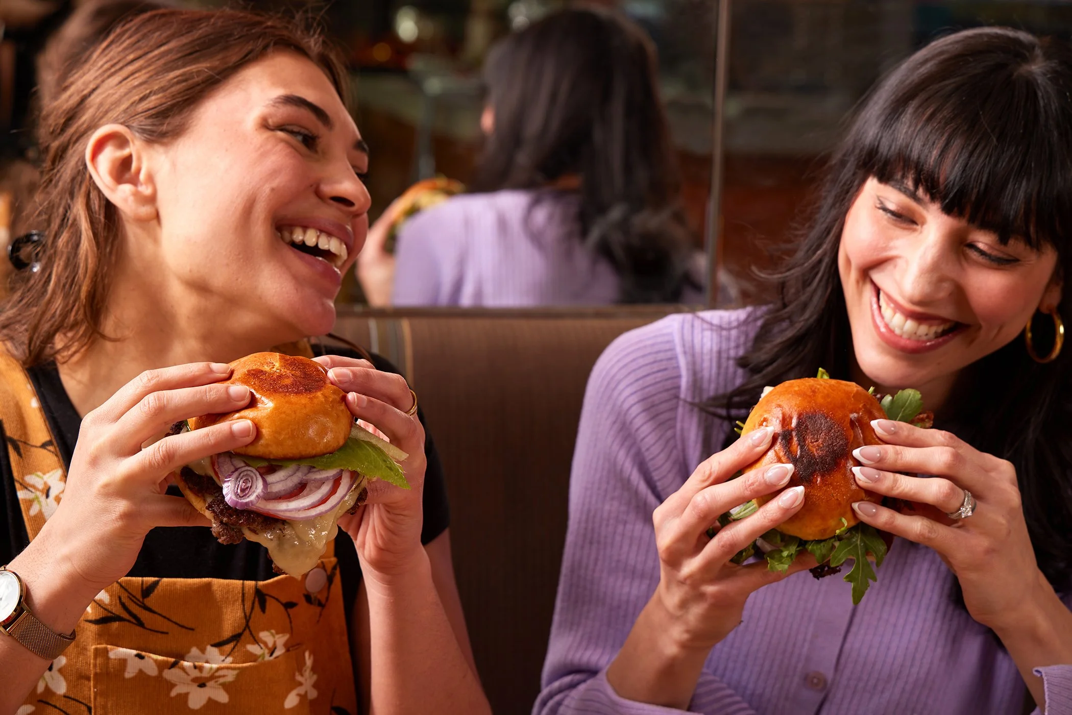 two girls eating a burger
